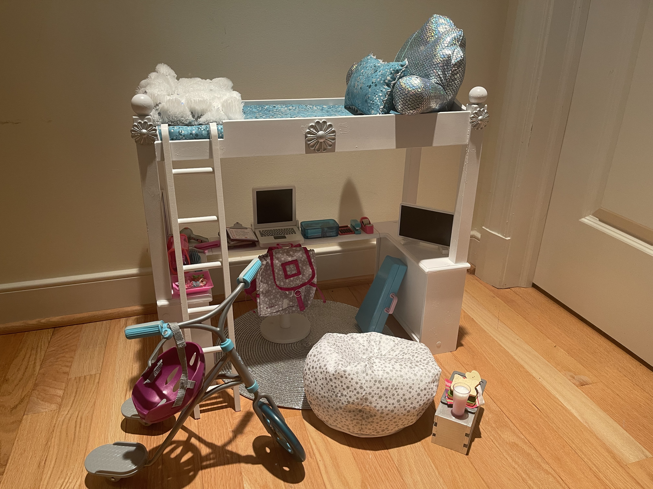 Loft bed features all bedding. included are a desk complete with supplies and a backpack. Also, a vanity area with a set of supplies. There is a bean bag chair and snack table for the tv-watching, area. Also included is a scooter and helmet. $136