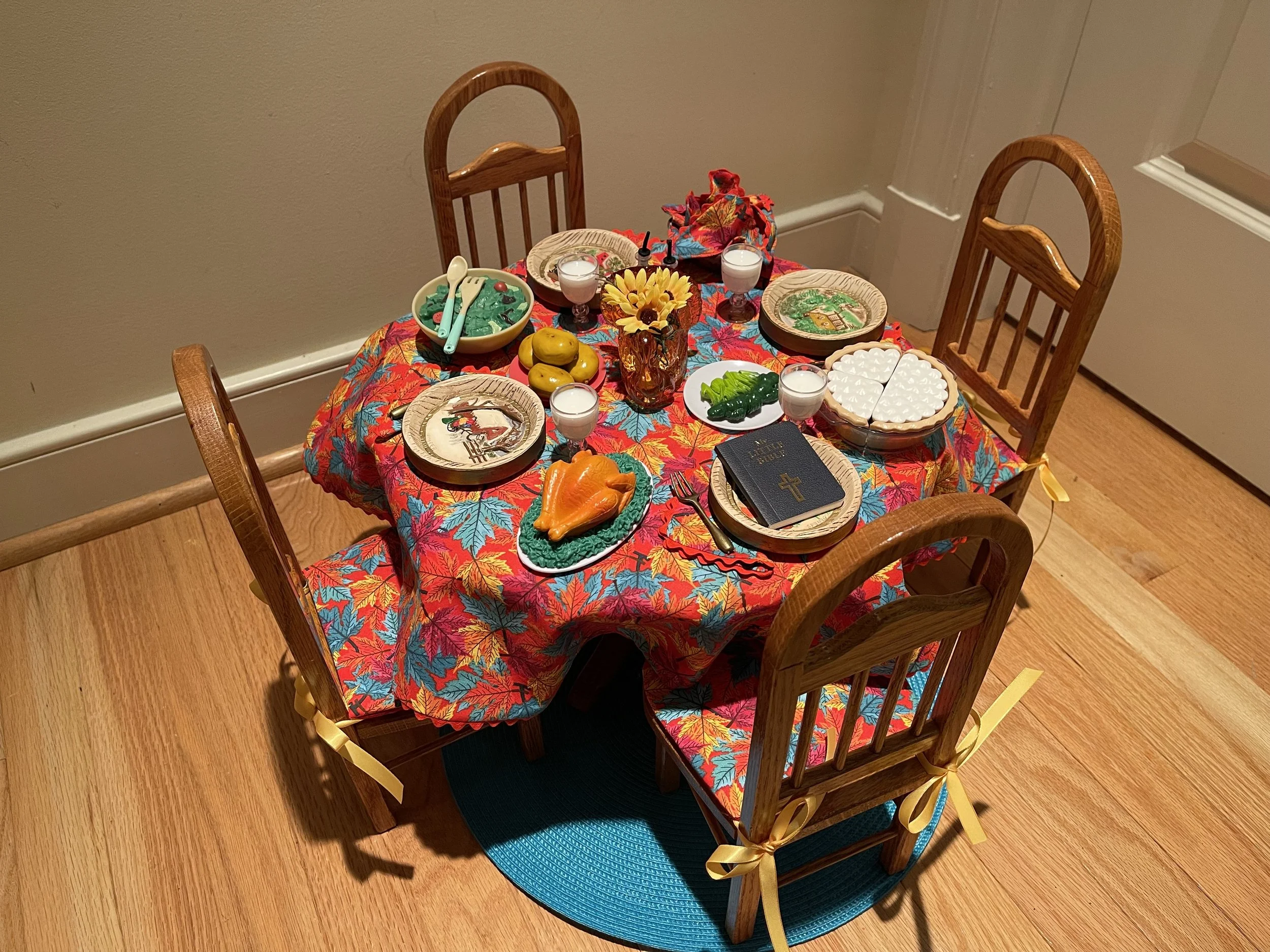 This beautiful table with 4 chairs is handcrafted and in perfect, sturdy condition. It now features all the delicious items for a holiday meal, including a Bible. $142