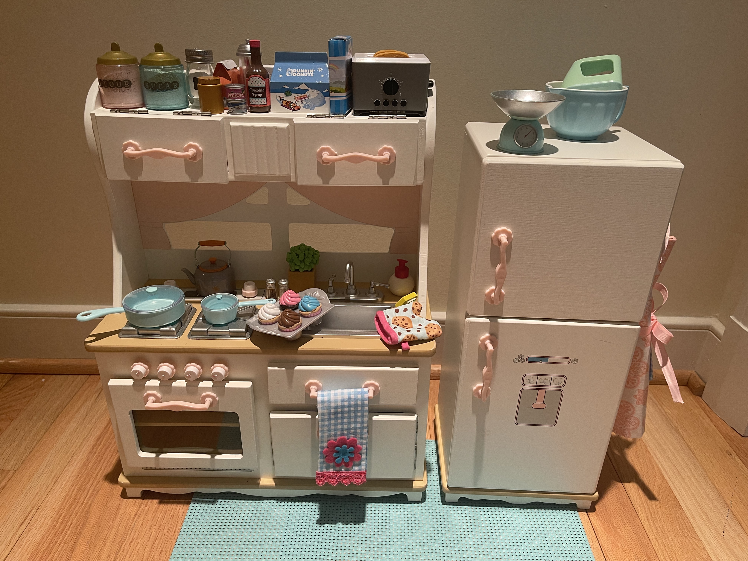 This wooden kitchen set was discontinued in 2009 and it's fabulous. Included are utensils in the drawer, a chicken in the oven, and a fully stocked refrigerator. Also included are an apron, dish towel, and cooking accessories. $95