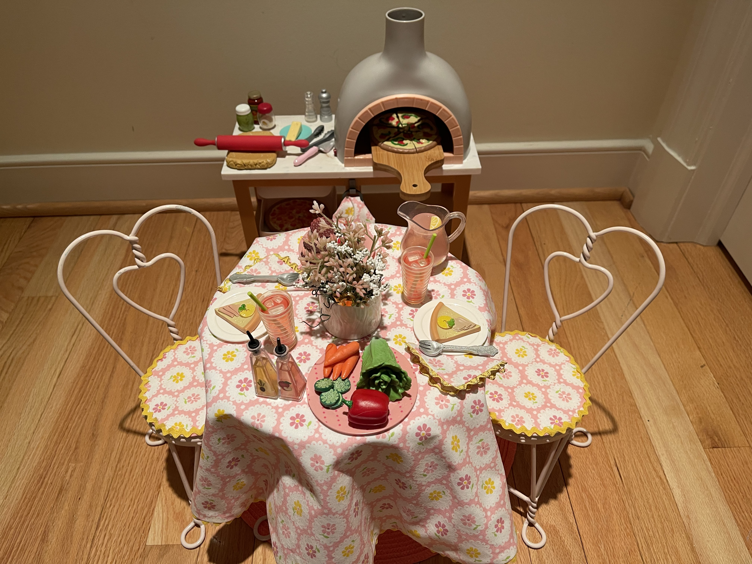 Pizza oven lights up and includes lots of fun cooking accessories. The dining table has everything needed for a fun meal. $98