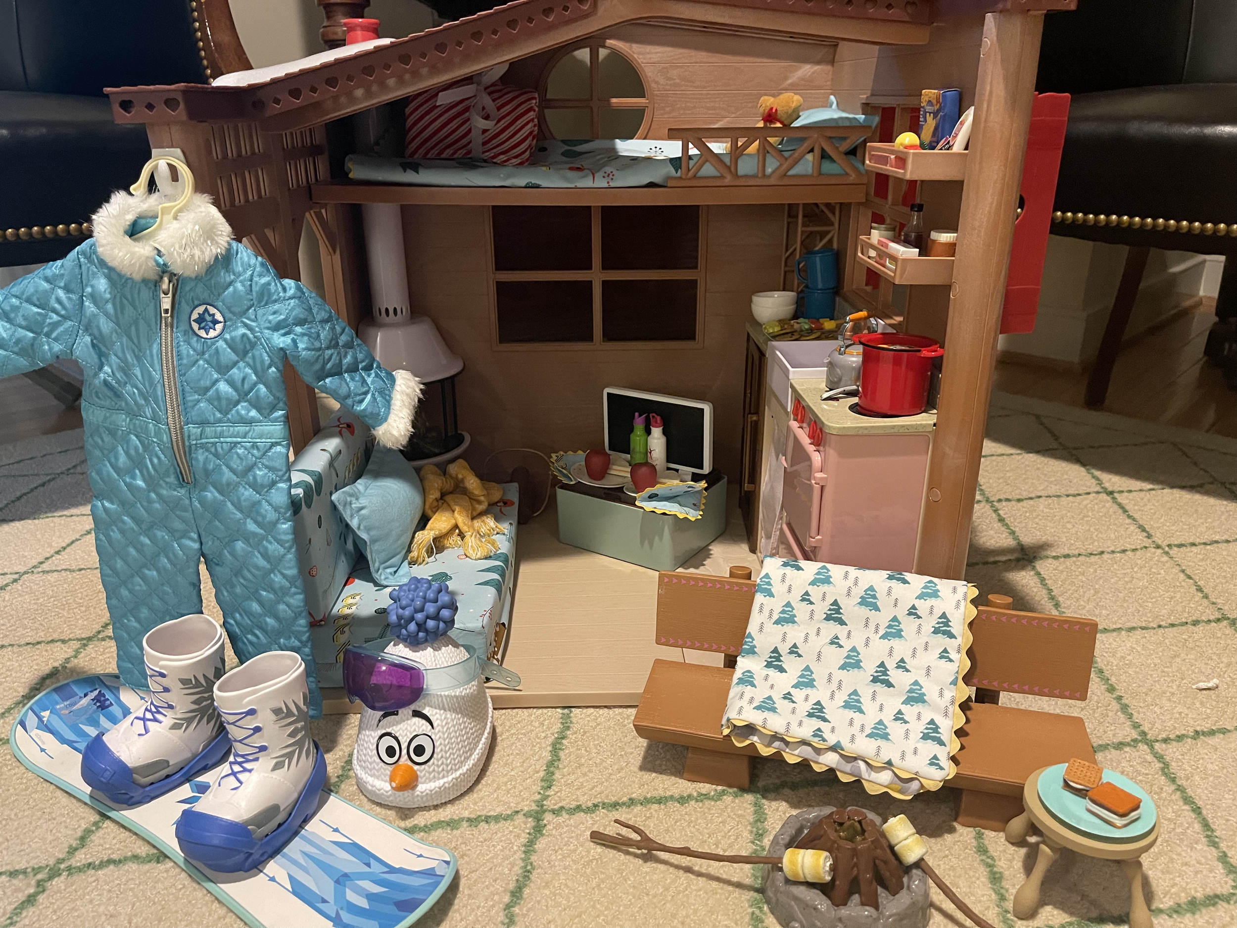 Up-cycled Winter Cabin 1 features accommodations for 2 - a loft bed plus sleeping bag, sofa, food and supples for several meals. One featured item is a snowboard with coordinating outfit! Outdoor light-up fire pit and s'mores are all included. Indoor