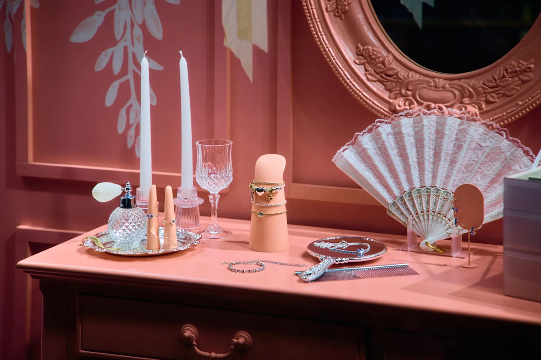 closeup image of retail display table at Pandora x Bridgerton illustrated wisteria by Maggie Enterrios