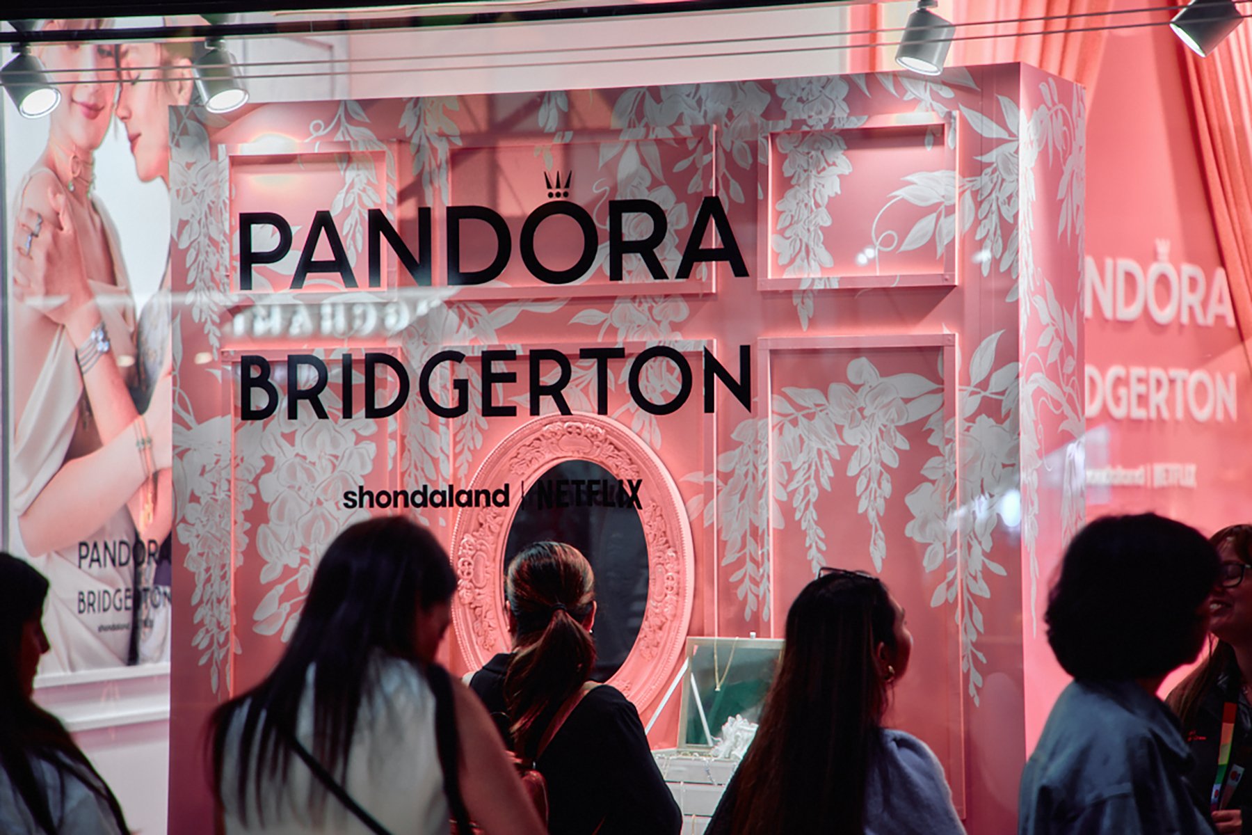 Image of Pandora x Bridgerton retail pop-up storefront window with illustrated wisteria by artist Maggie Enterrios