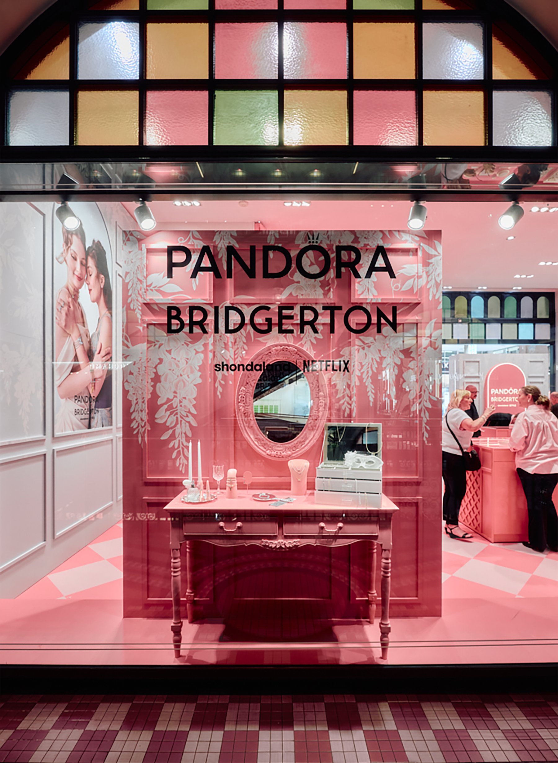 Image of Pandora x Bridgerton retail pop-up storefront window with illustrated wisteria by artist Maggie Enterrios