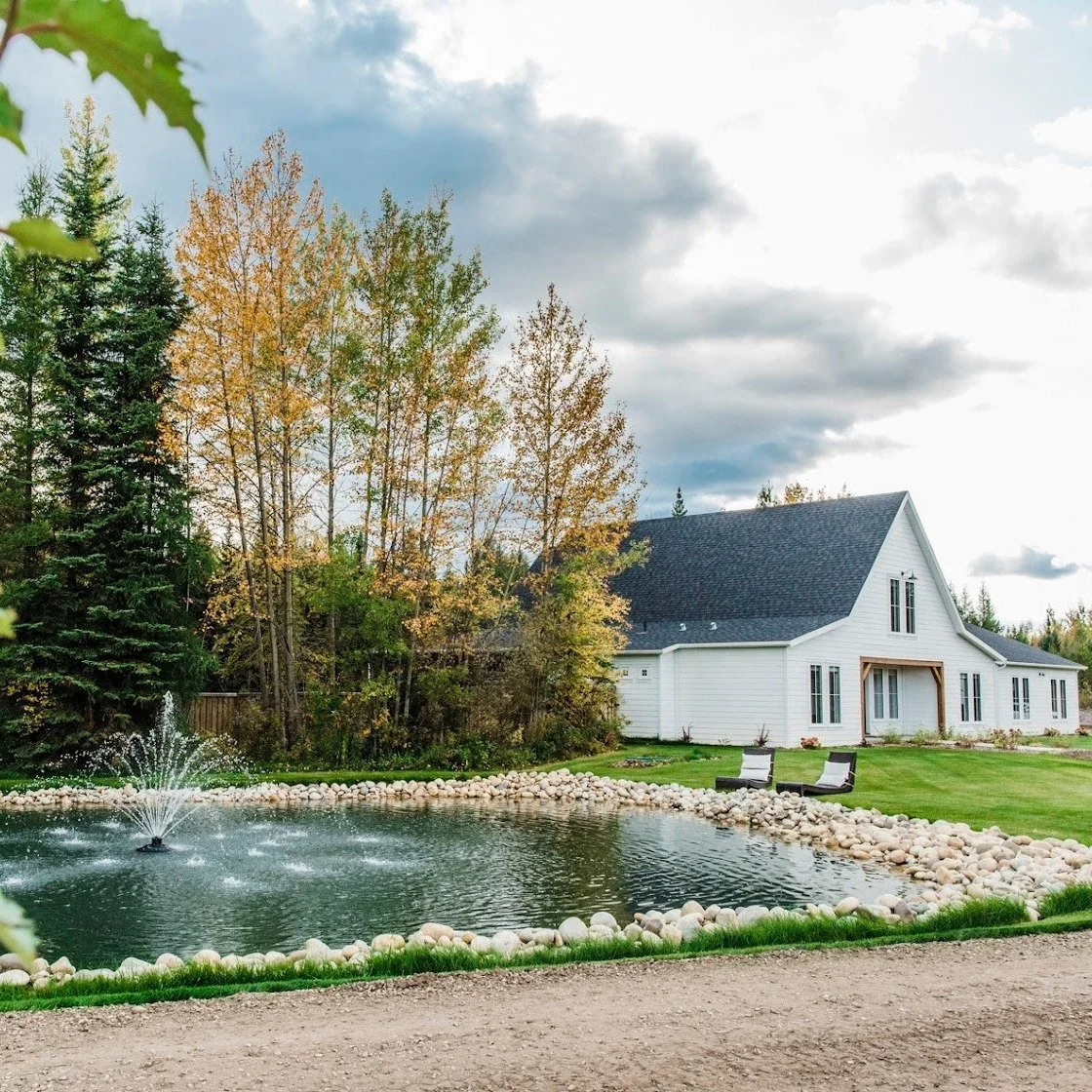 Lazy Sundays were made for a place like this, with a fountain on the pond and two chairs out on the lawn. A white farmhouse tucked into the trees, room to breathe, and nowhere to be. See more at blackrockhomes.ca.
#GrandePrairie #YQU #PeaceCountry #B