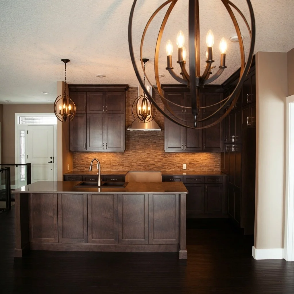 Custom home kitchen with espresso cabinetry, island and globe chandelier