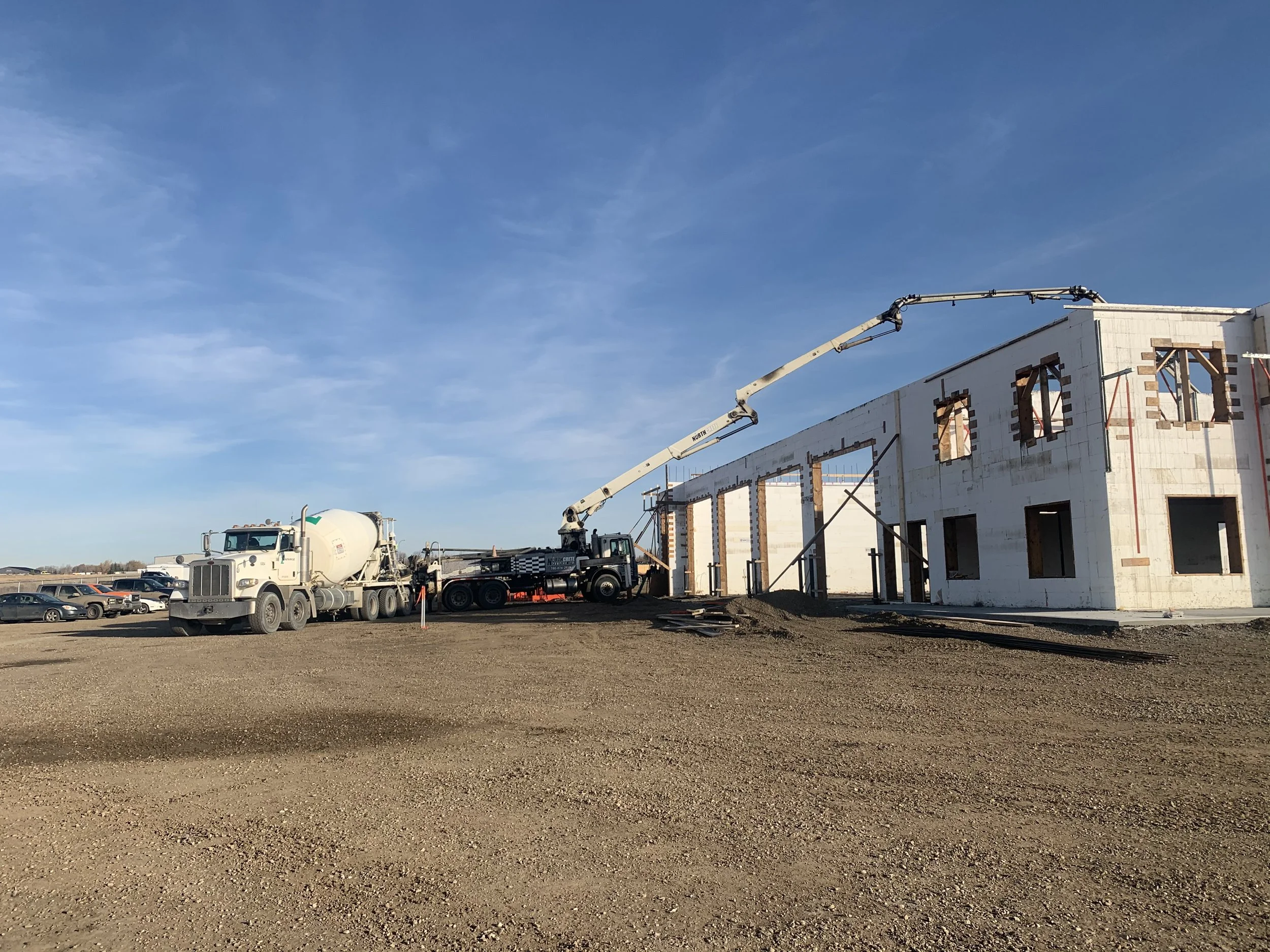 Crews pouring concrete on a ICF Office and Shop by Blackrock Homes & Commercial in Grande Prairie, Alberta