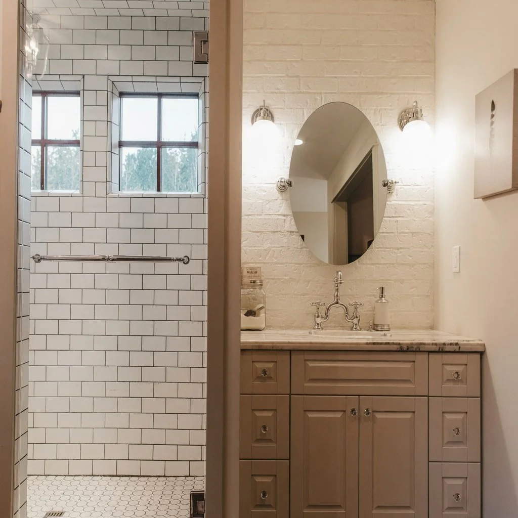 Custom home bathroom with subway-tiled walk-in shower and wood vanity