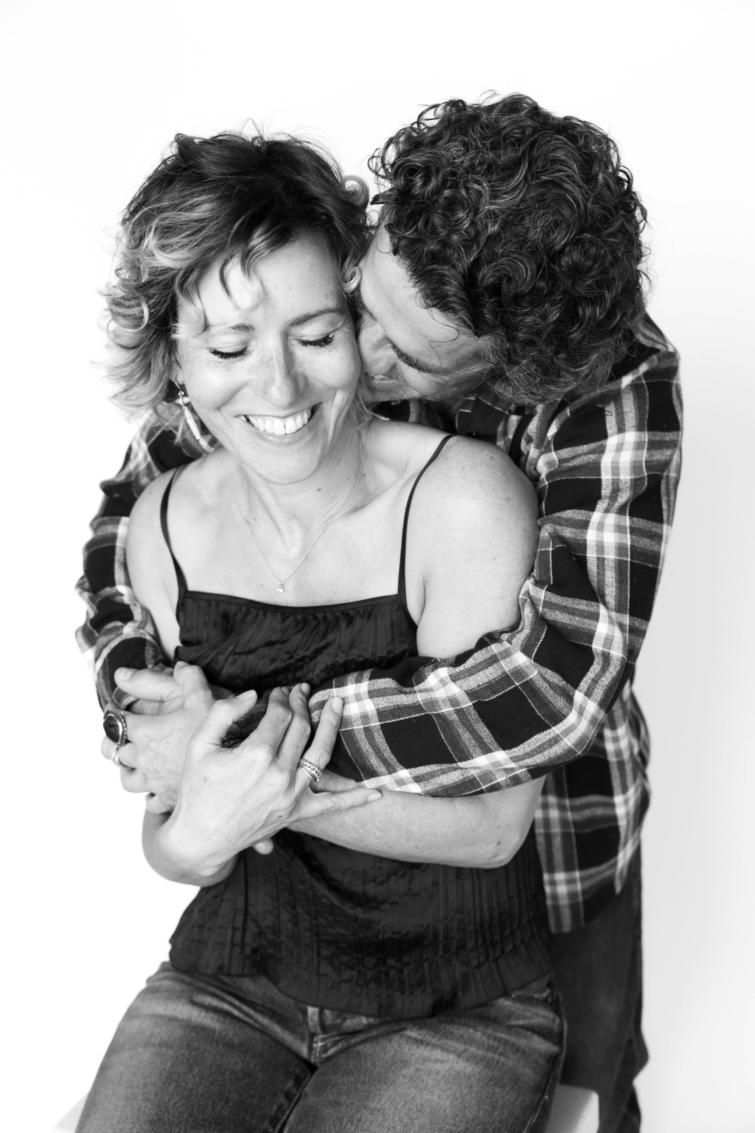 Joyful and spontaneous black and white couple’s portrait captured during a Just BE Experience near Shell Beach—celebrating love, laughter, and true connection.