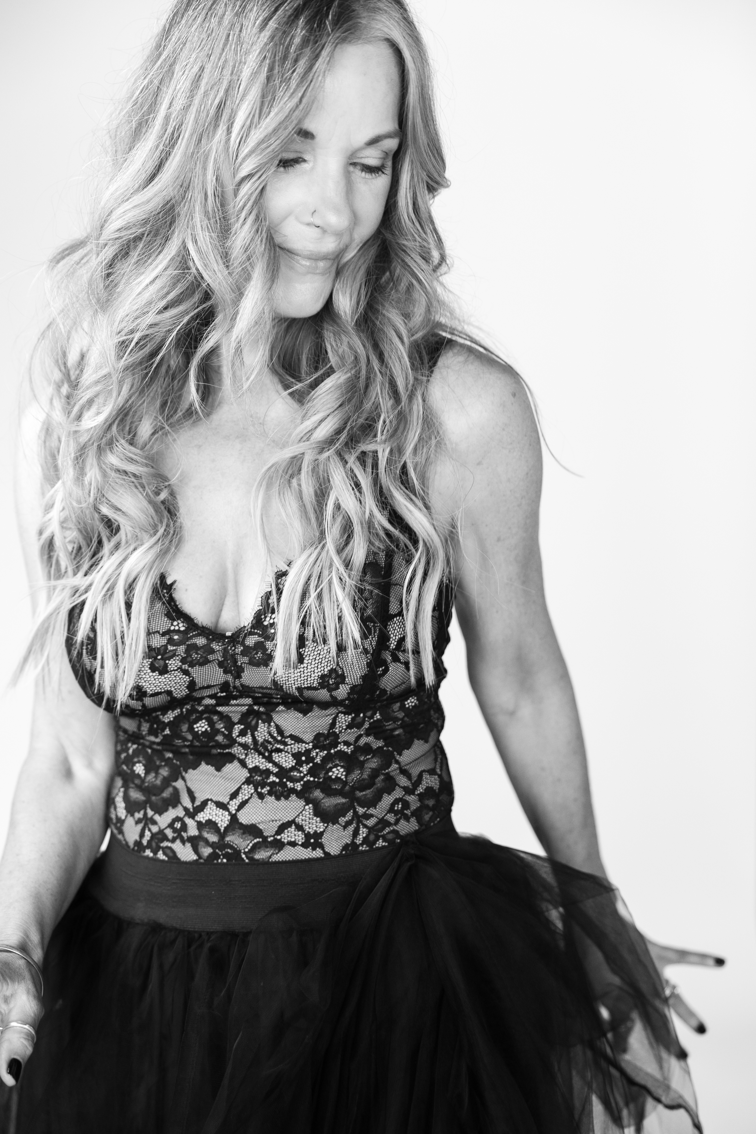 Joyful black and white portrait of a woman dancing freely during her Just BE Experience photo session near Arroyo Grande, CA.