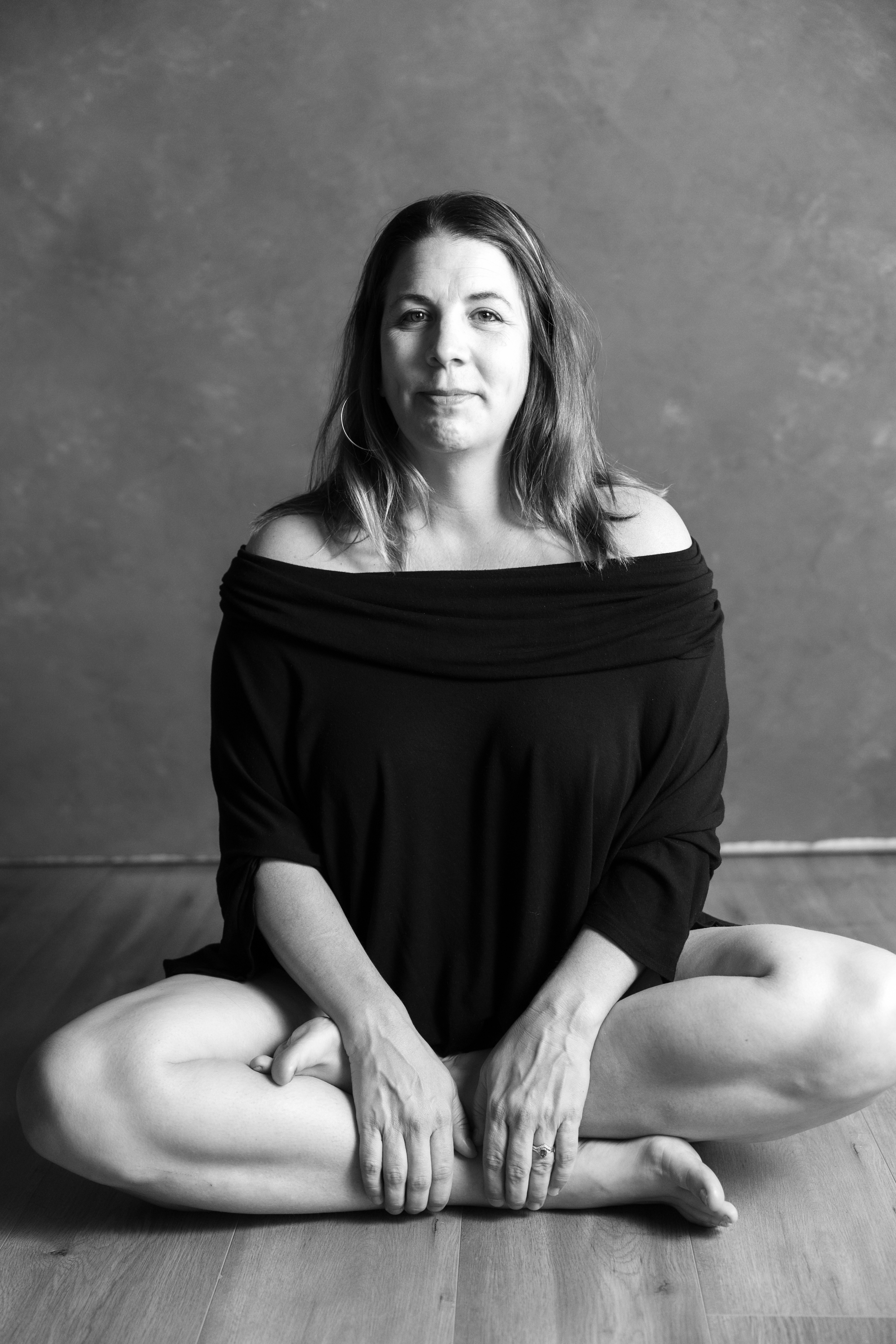 Candid black and white self-love portrait of a woman sitting cross-legged —Just BE session in San Luis Obispo, CA