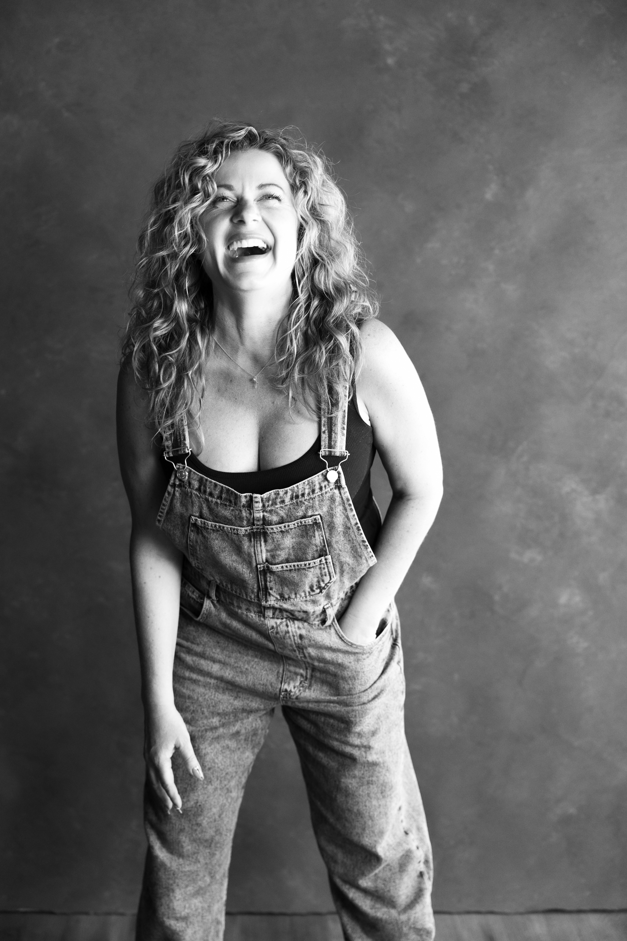 Beautiful candid portrait of a woman with a genuine laugh in studio portrait session near Pismo Beach CA. 