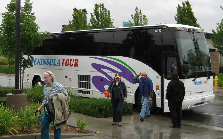 people exiting a tour bus on a co-op tour