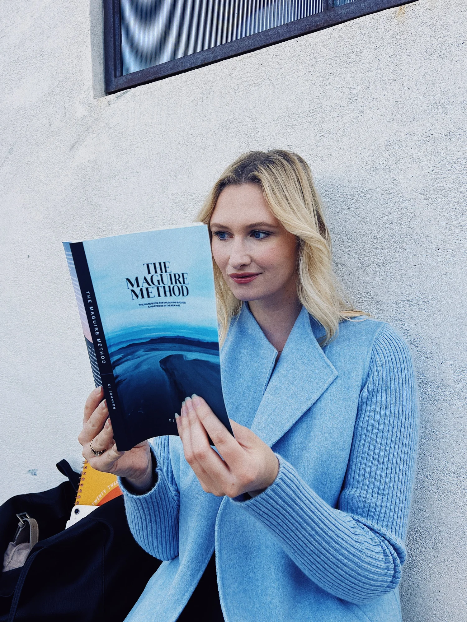 A reader holding The Maguire Method