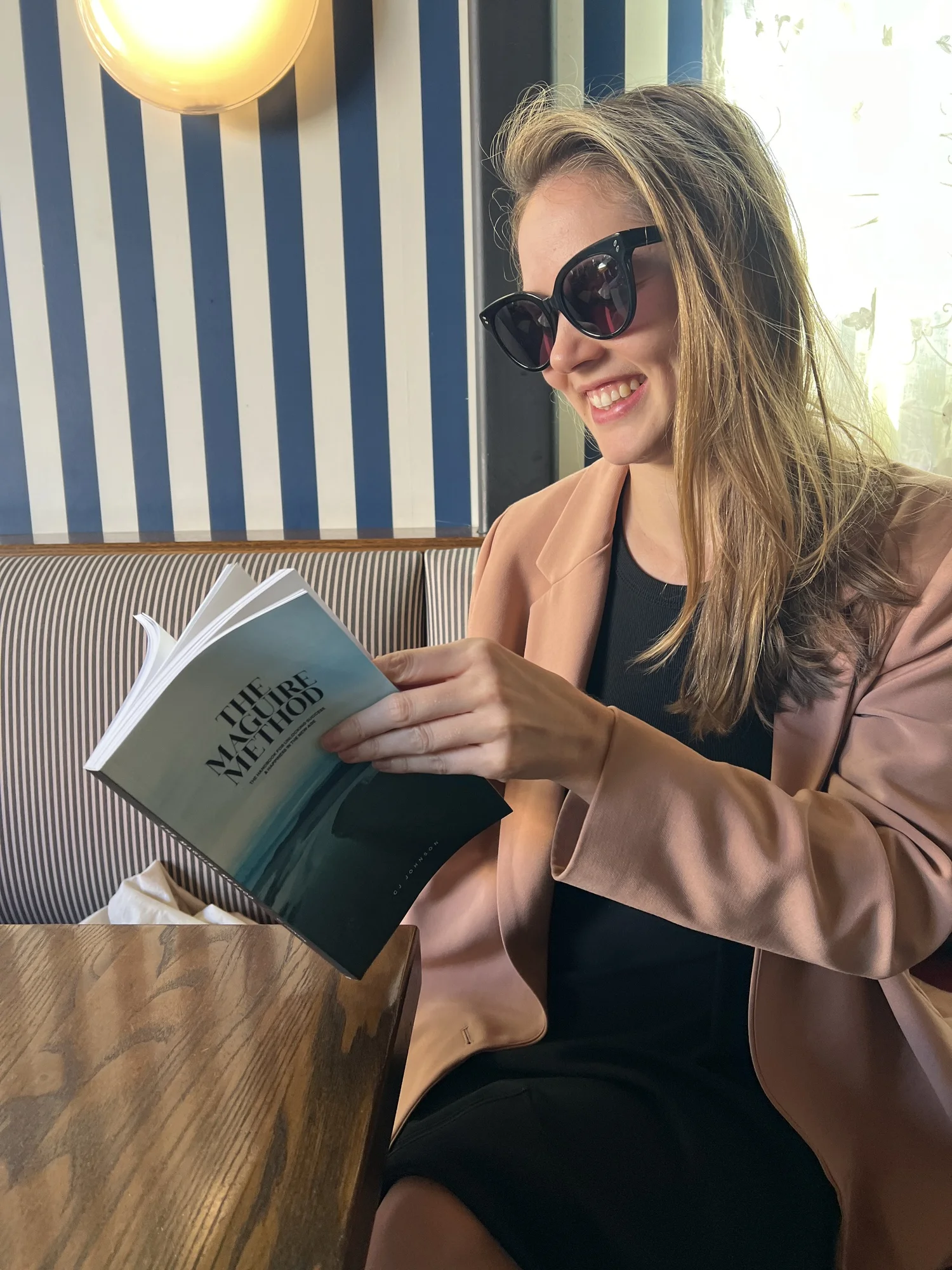 A reader with The Maguire Method at a cafe