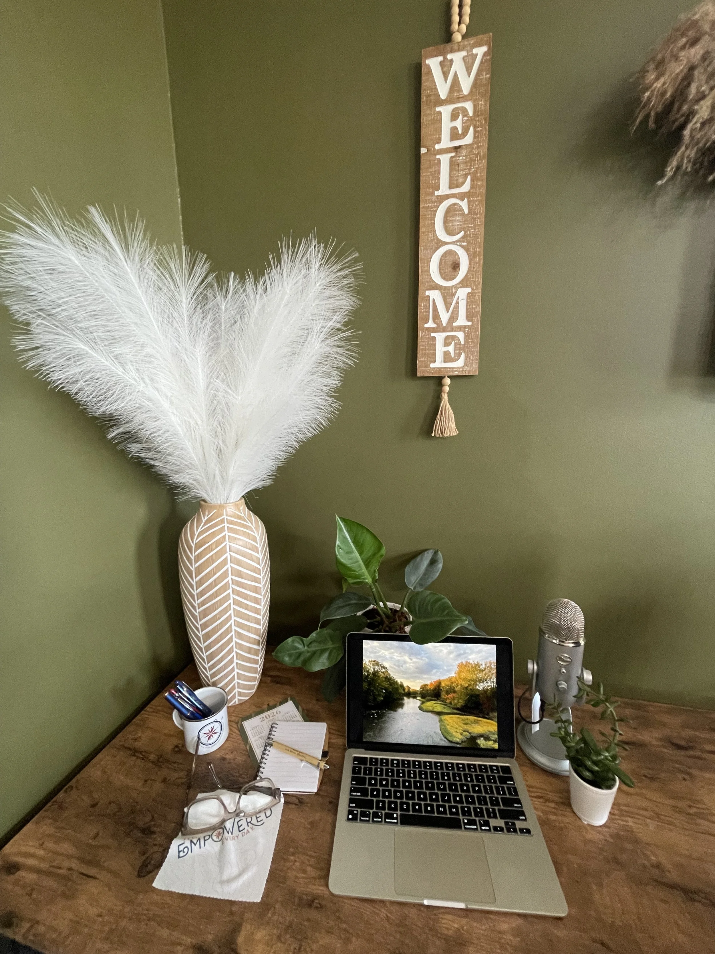 a desk with a laptop and several accessories