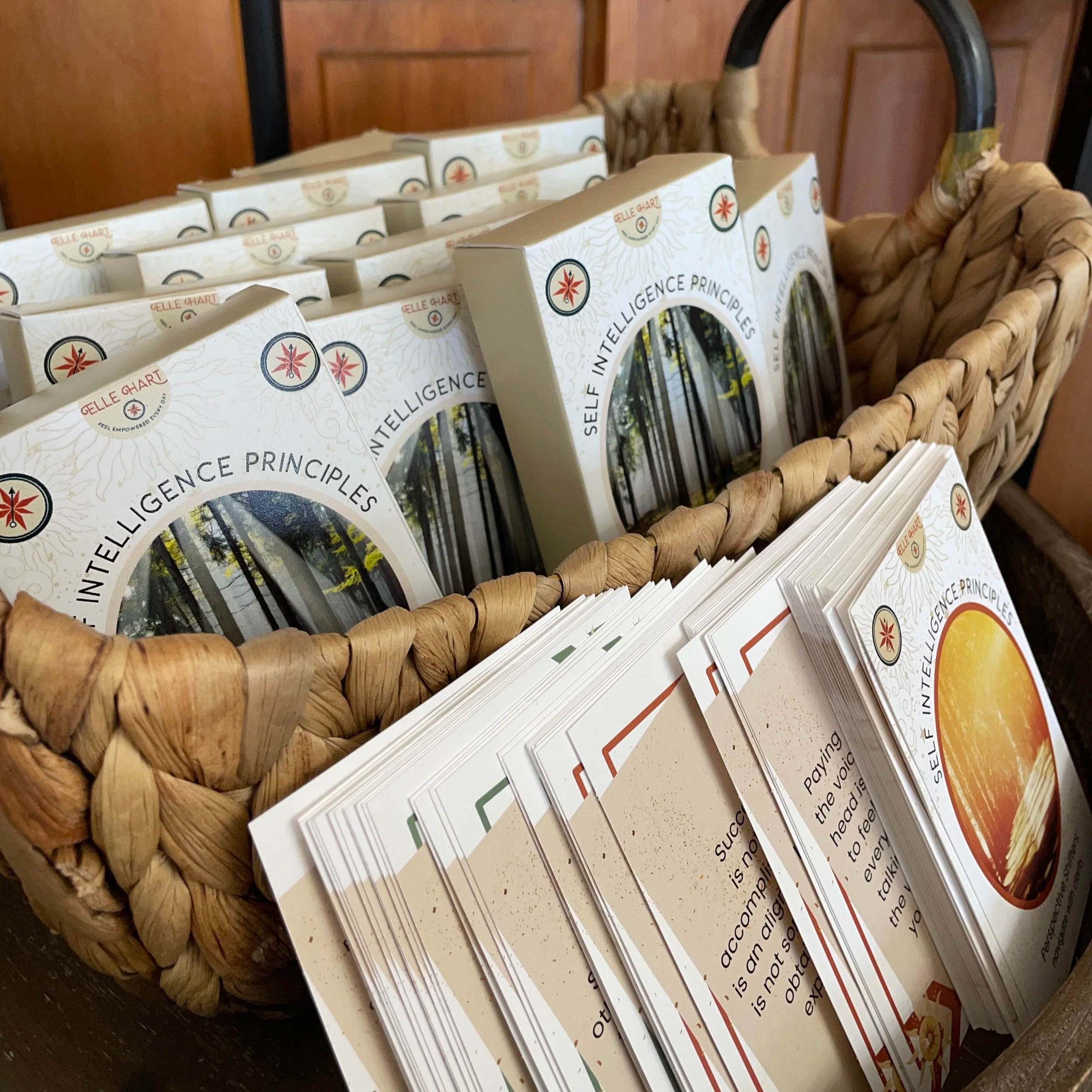 a basket holding several decks of self intelligence principles card decks