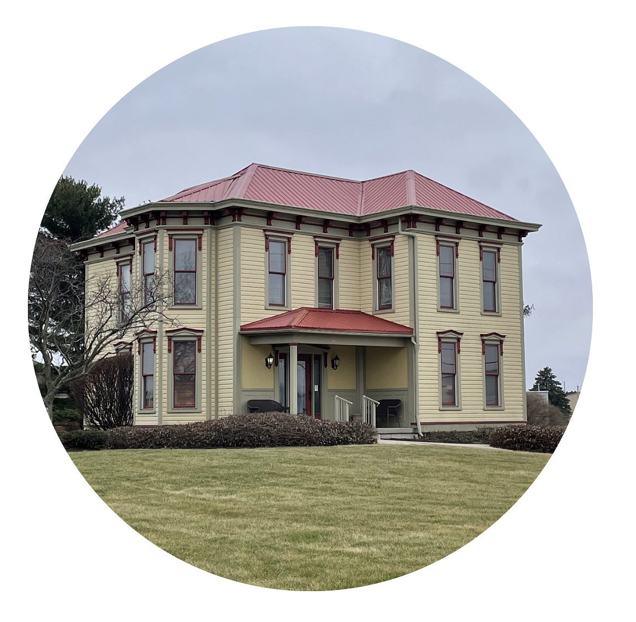 a yellow manor with a red roof in troy ohio