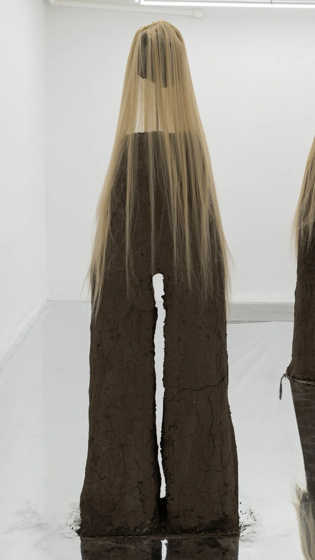 Kiyan Williams,  Sentient Ruin 8 , 2022, 
earth, binder, chrome, synthetic hair, steel base and armature, 72 x 27 x 30 inches, 182.9 x 68.6 x 76.2 cm