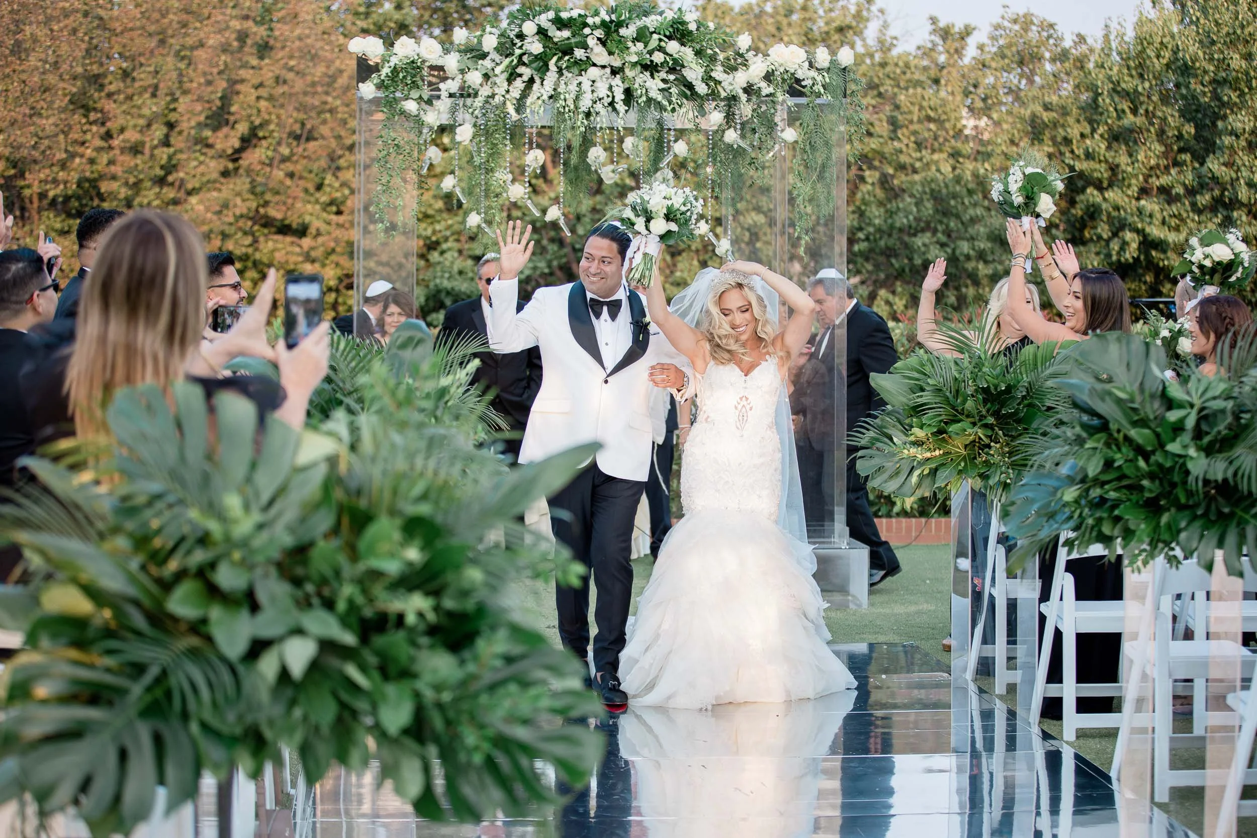 a bride and groom turn to face their guests as they are announced husband and wife.