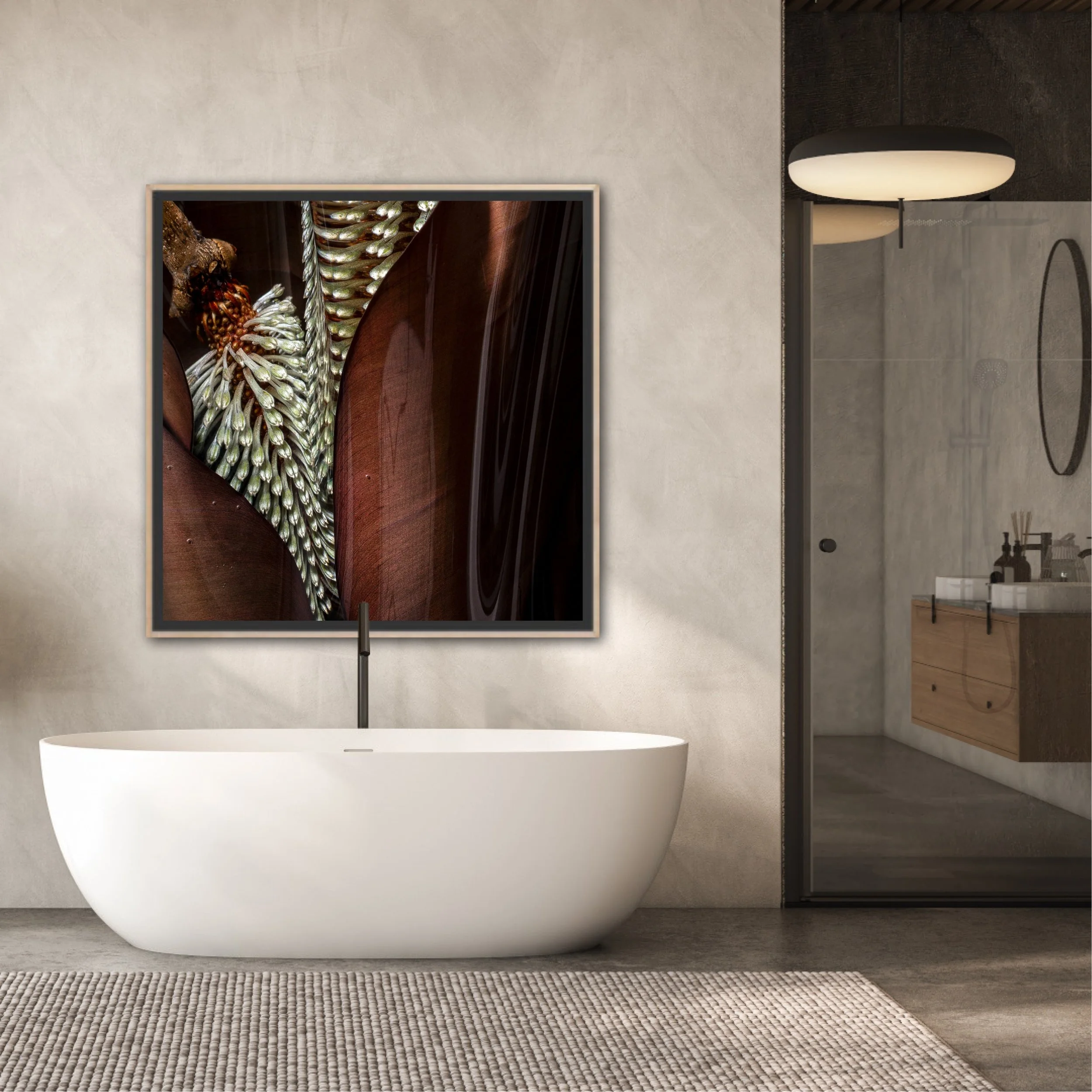 Modern bathroom with a freestanding white bathtub, a textured beige rug, and a large wall-mounted art piece. The bathroom features a gray wall, a glass shower enclosure, and minimalistic fixtures.