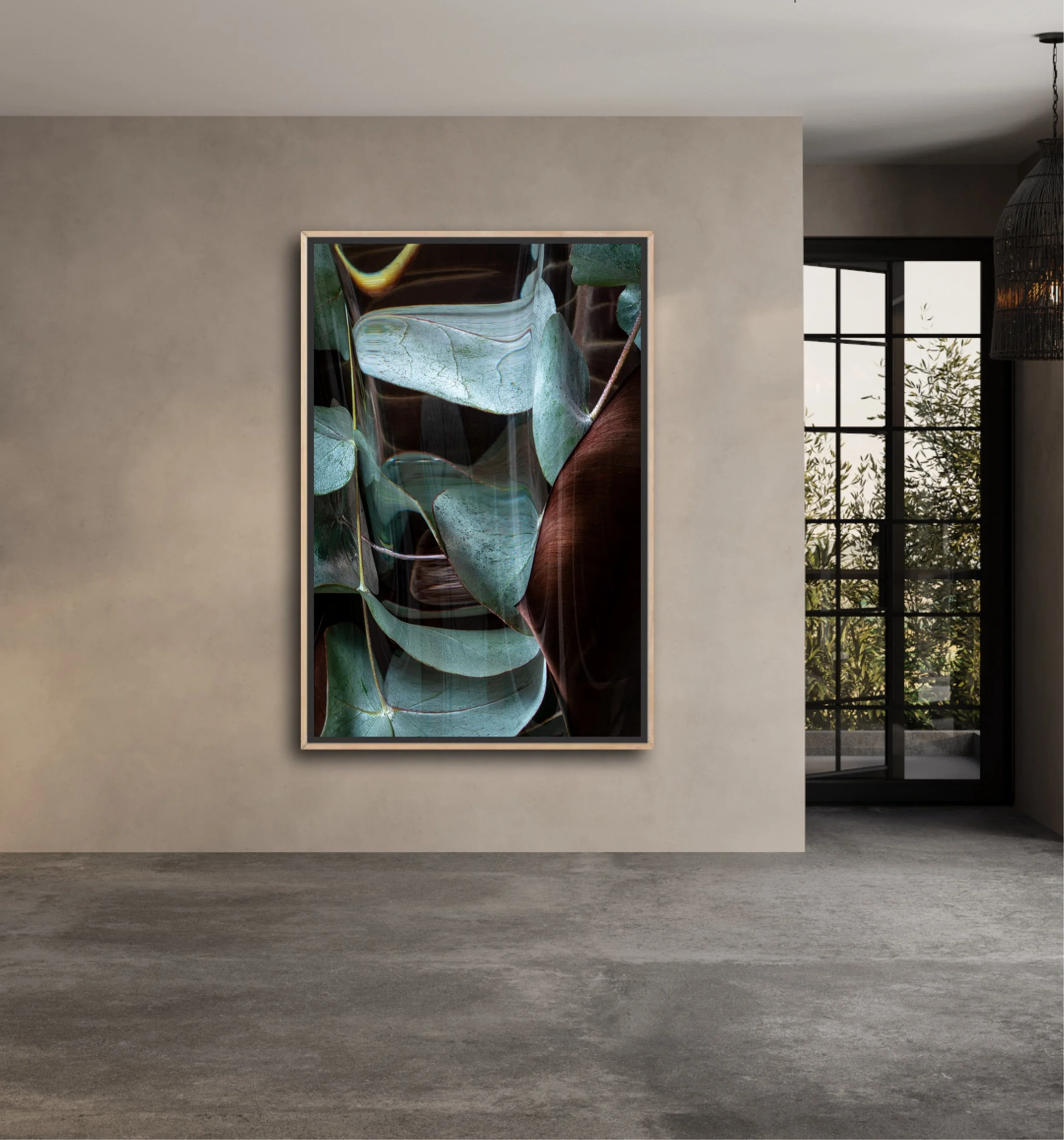 Minimalist art gallery with a framed abstract painting of green leaves on a gray wall, large window with black frames, and black hanging light fixture.
