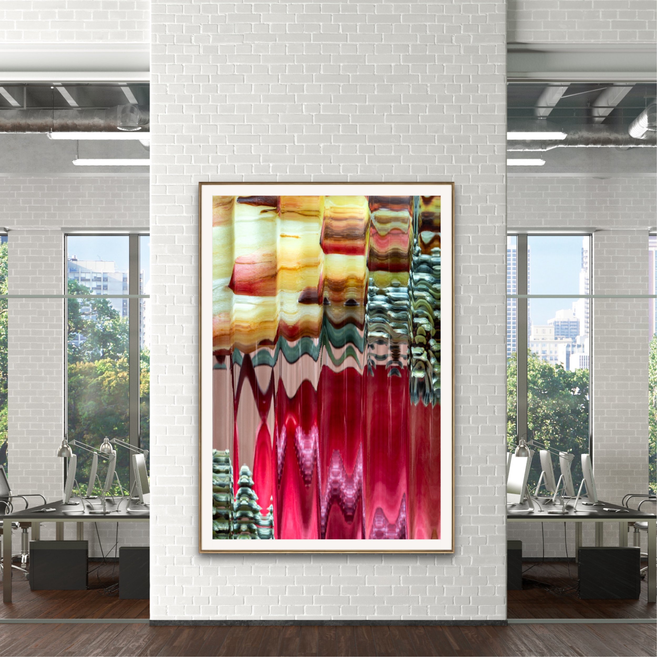 Modern art gallery with white brick walls, large windows, and a framed colorful abstract painting. The gallery is spacious with chairs and tables in the seating area.