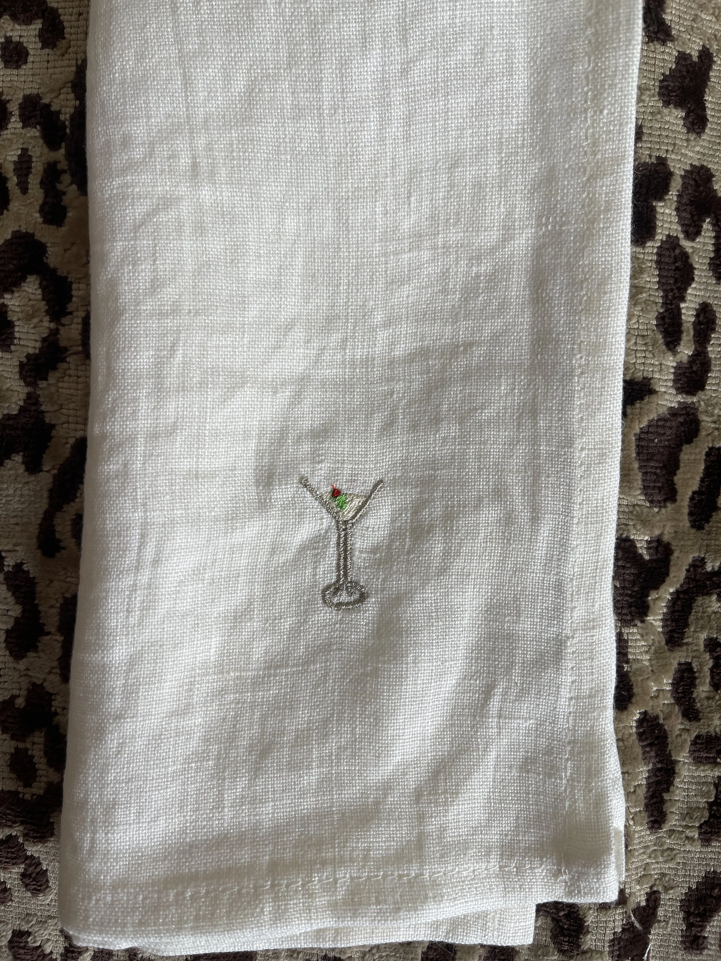 Embroidered dirty martini on a white napkin