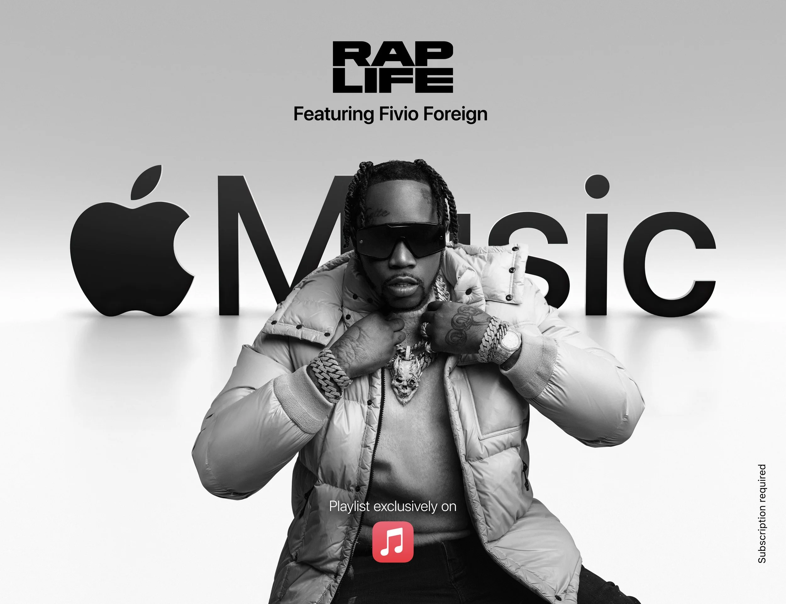 Black and white advertisement featuring rapper Fivio Foreign wearing sunglasses, a puffer jacket, and jewelry, in front of an Apple Music background with the text 'RAP LIFE' and 'MUSIC'.