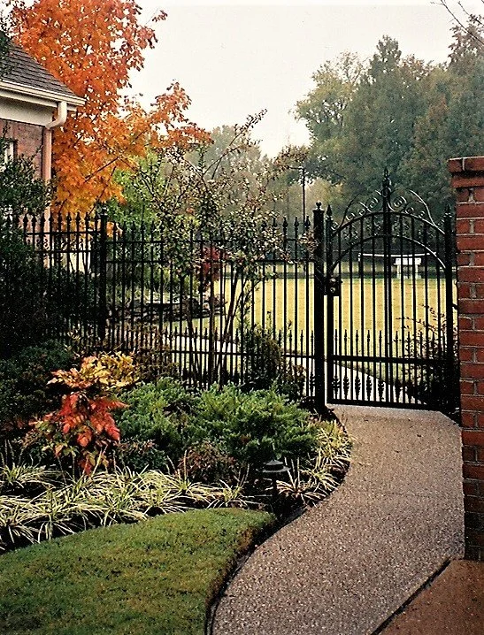 metal gate with landscaping and walkway