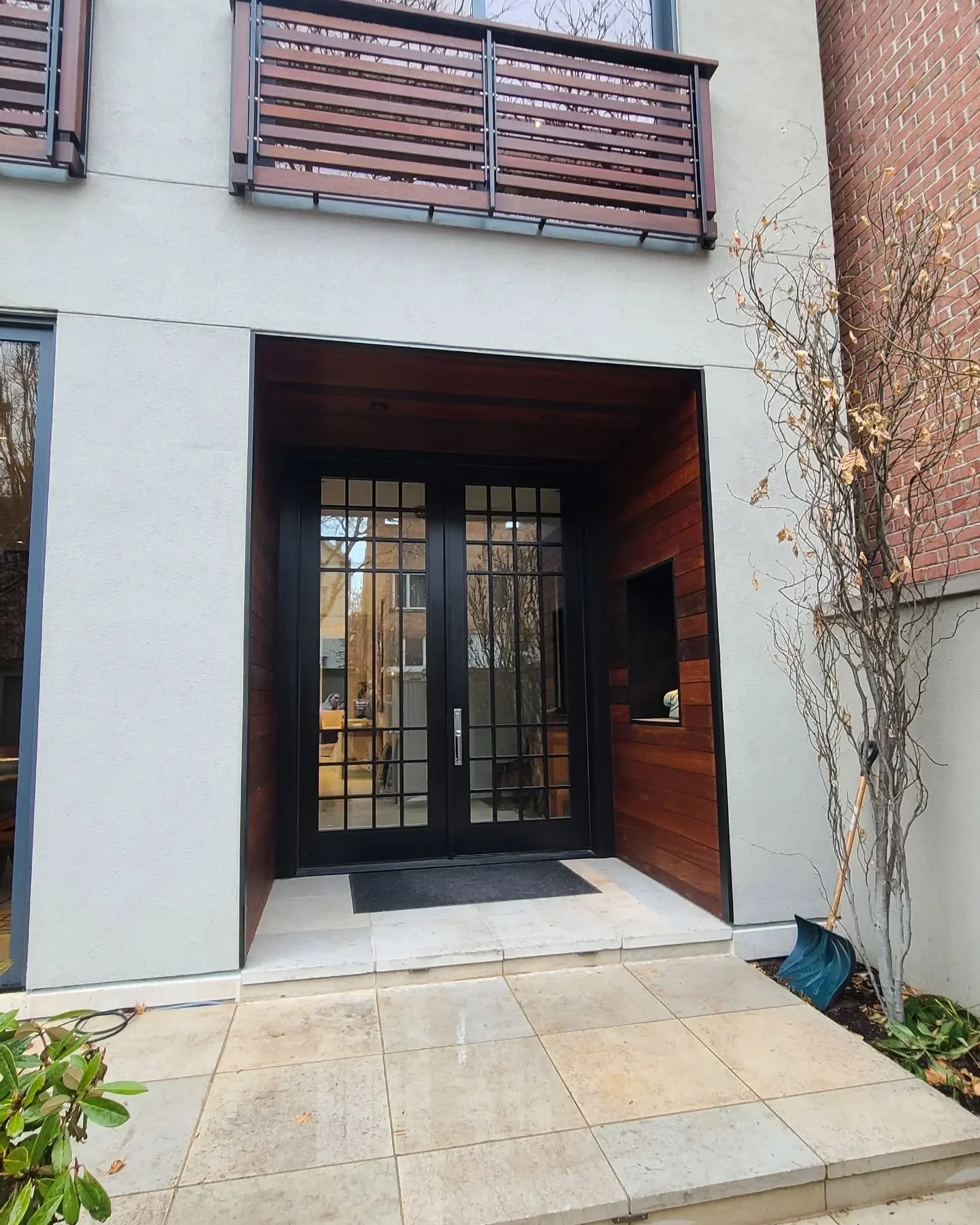 Swipe to see the before.  Updating this 1980s modern home comes alive with adding layers of textures, colors, and light.  Every time I walk into this new surround, I feel the warmth of the space beyond and it inviting me into the home.