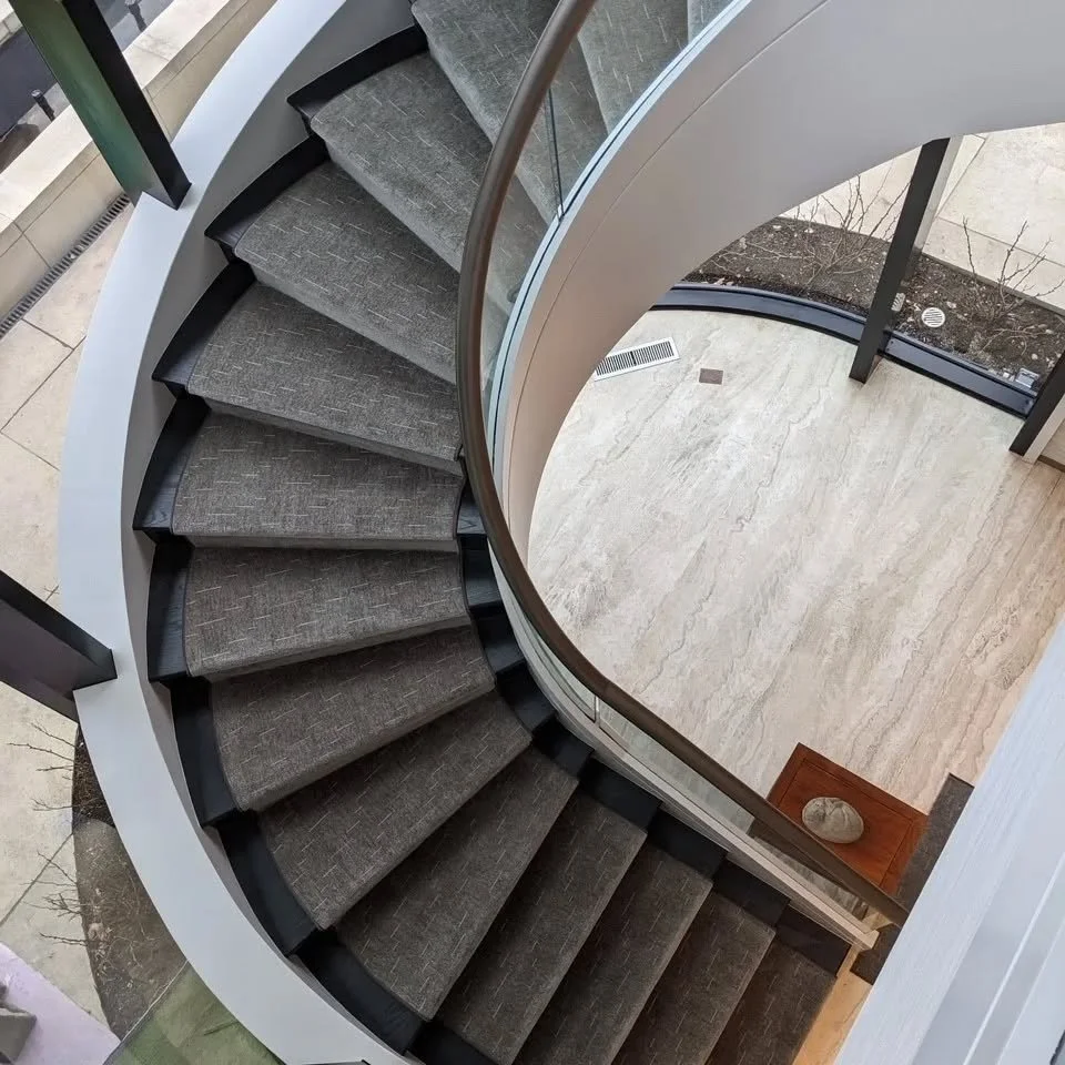 This 1980s stair was stripped of its cream colored carpet to find  unfinished white oak treads that had never been touched.  What a shame!  New life was brought to the stair by staining the treads black, painting the risers black and this beautifully