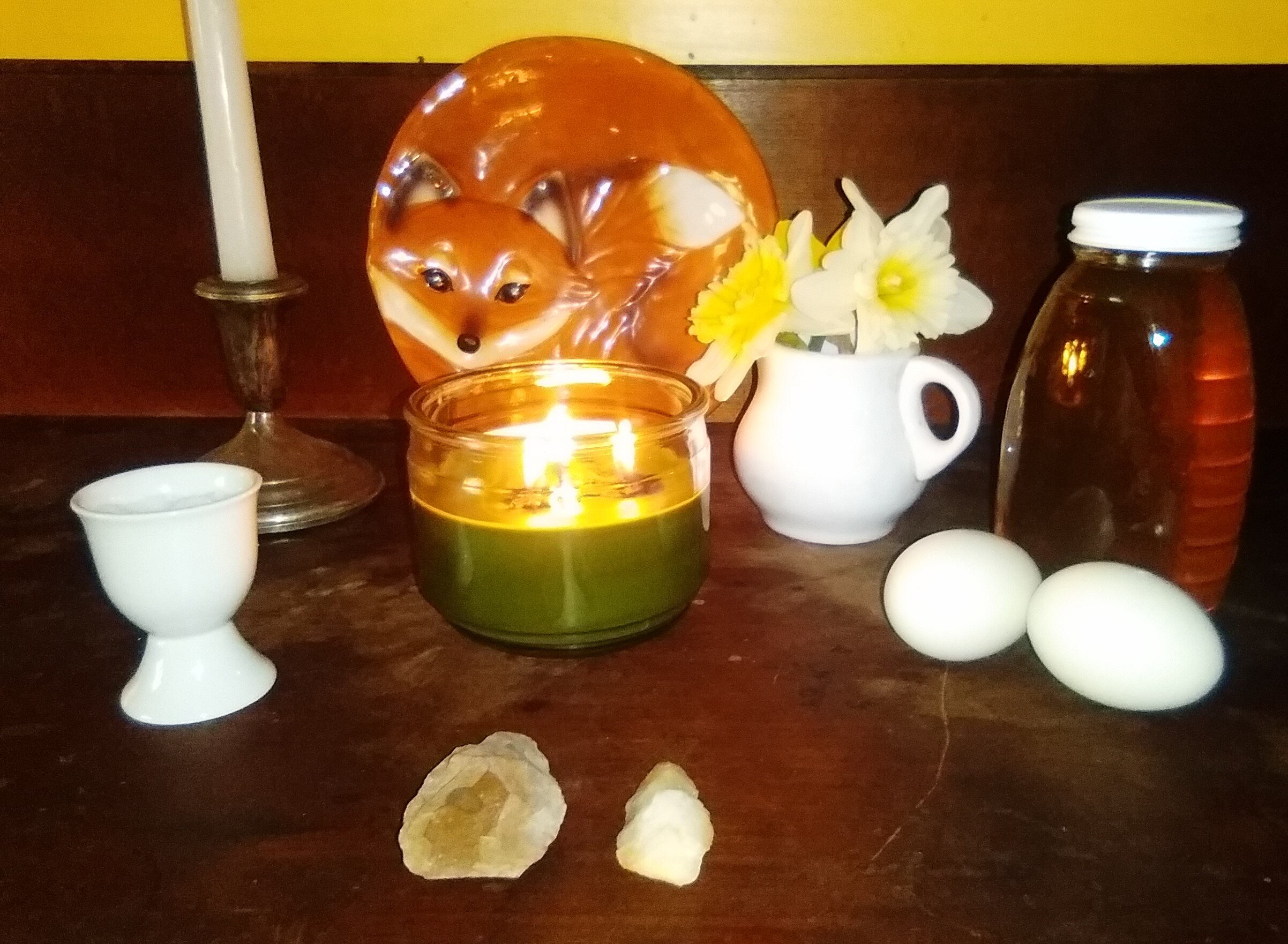 Altar to welcome spring. Here I have a green candle for growth and fertility . The white candle represents new beginnings. Photo by author.