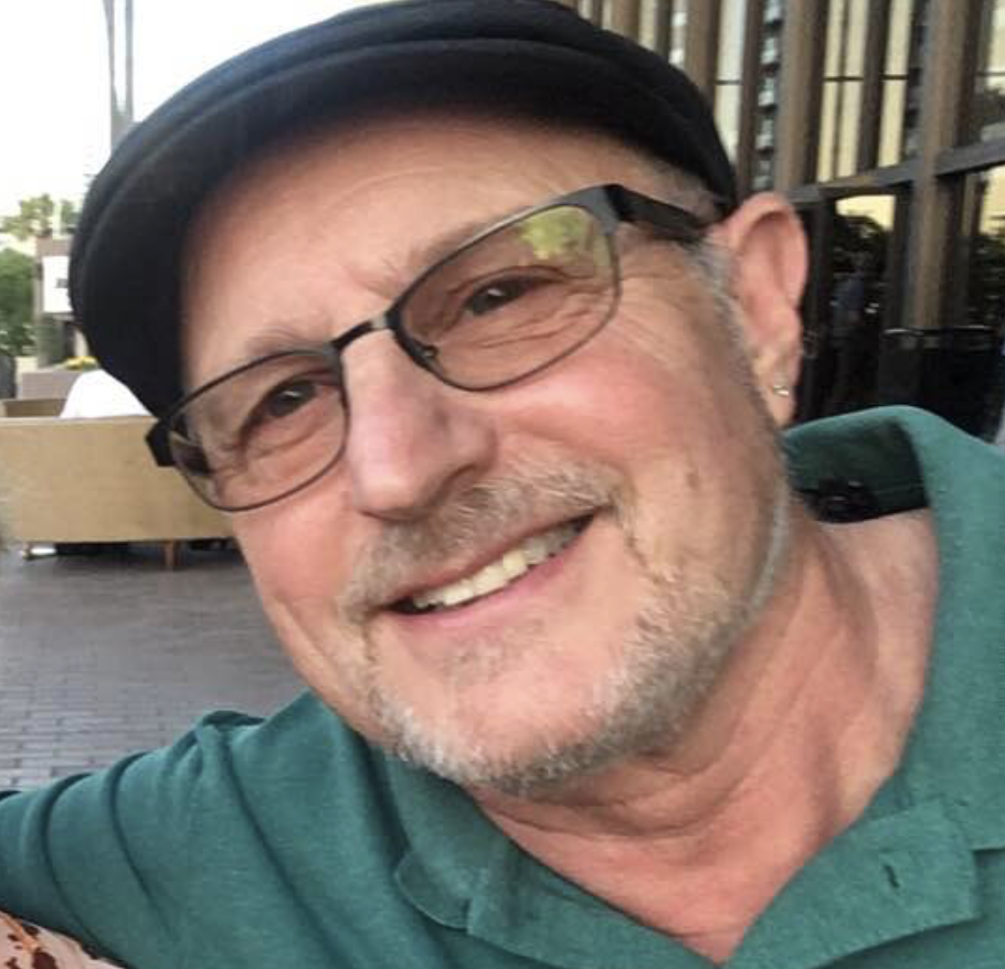Smiling man with glasses and short hair indoors