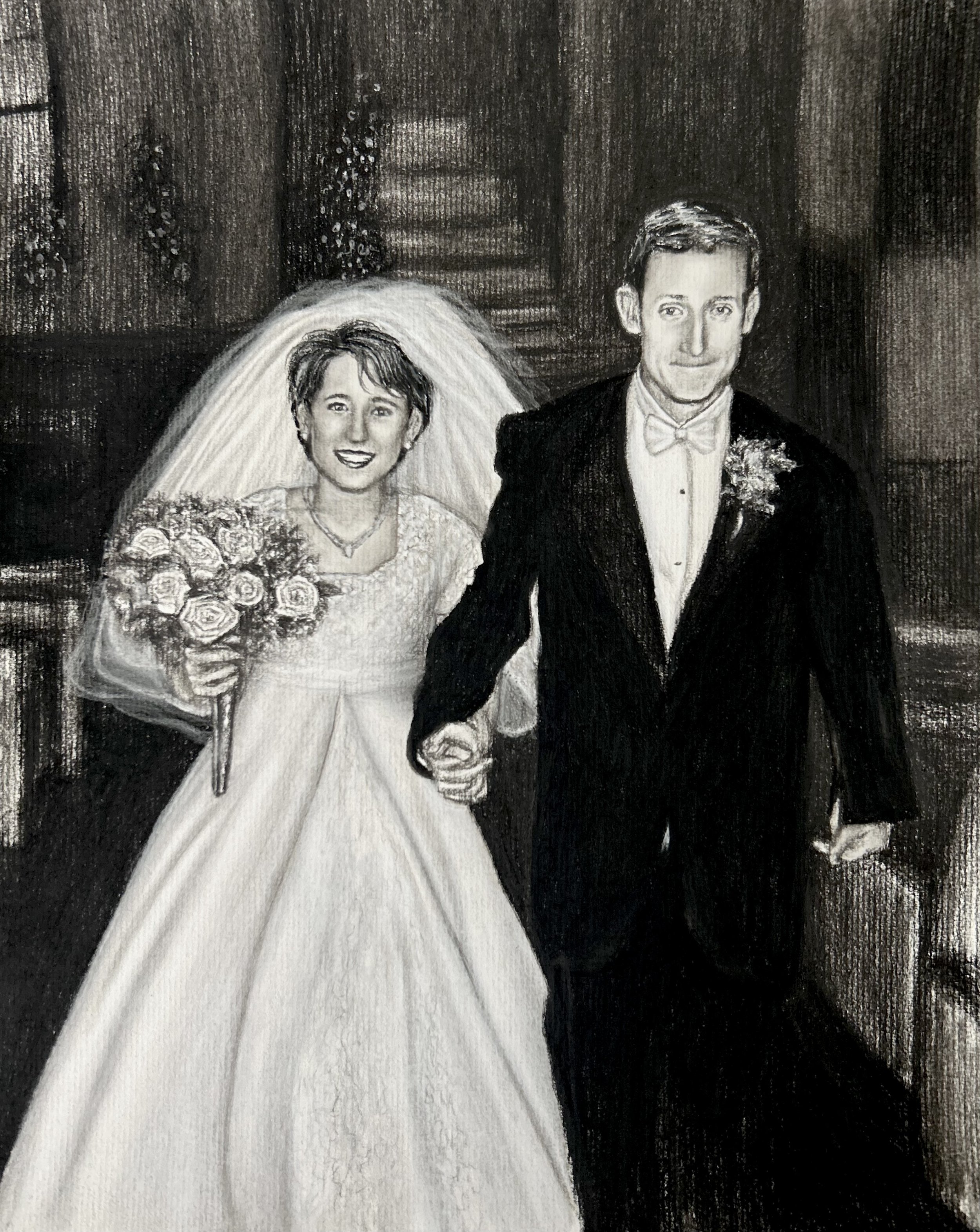 Commissioned gift charcoal wedding drawing of a bride and groom holding hands, with the bride in a wedding dress and veil holding a bouquet of flowers, and the groom in a tuxedo, in a church.