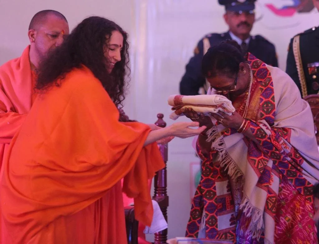 Sadhvi Bhagawatiji Saraswati Ji gifting holy cloths to a local woman.