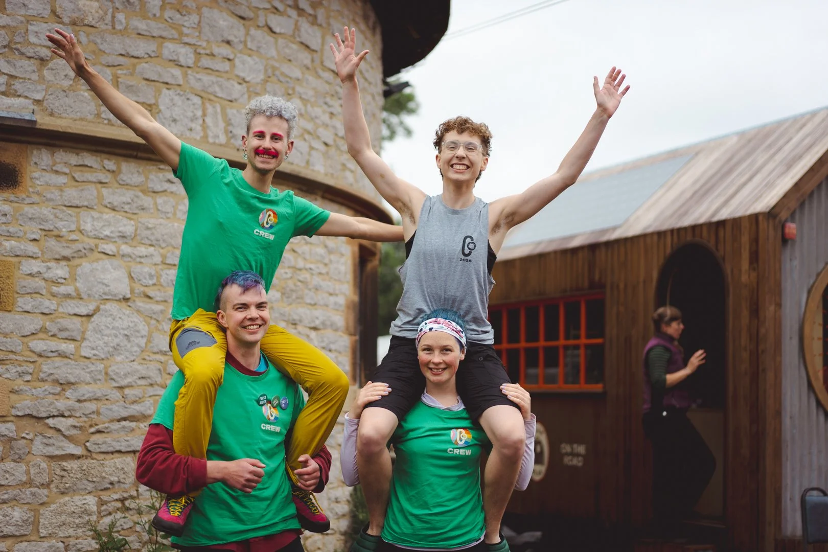 Four ClimbOut organisers together - two of them are on the other two's shoulders with their arms outstretched
