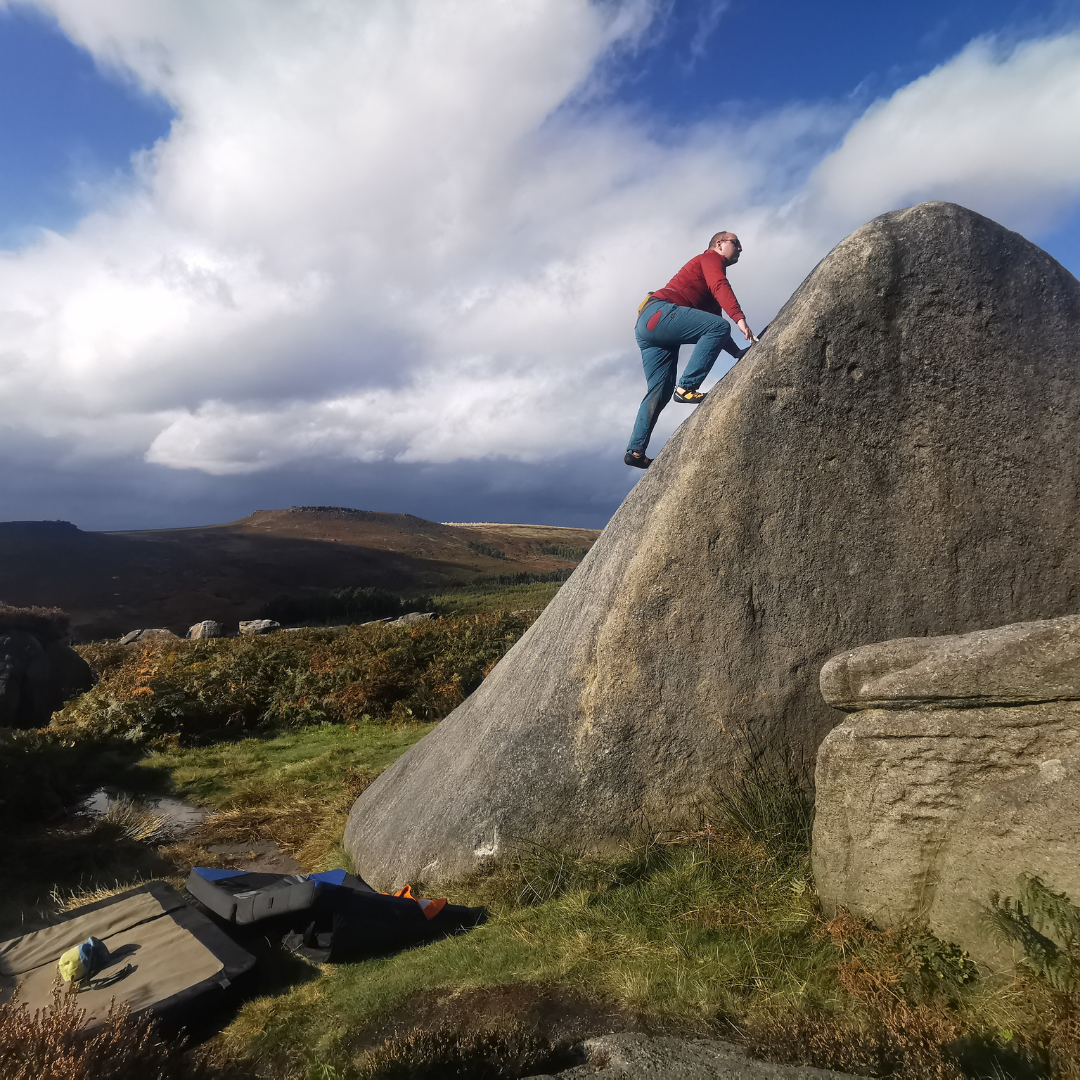  Spencer climbing a tall boulder  