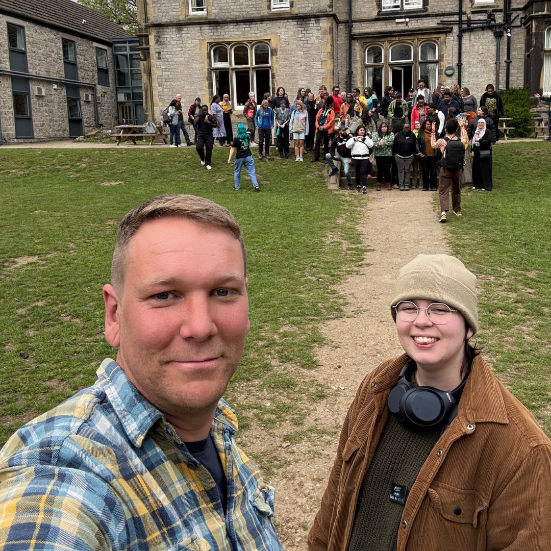  Mimi and Stu taking a selfie The 2026 Outdoor Connection, with a large group of people behind them&nbsp; 