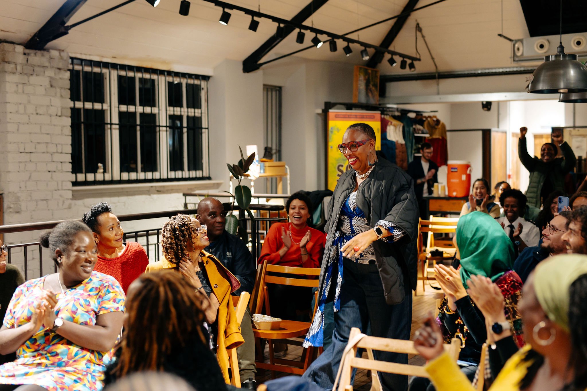  Person smiling as they walk towards stage to collect award 