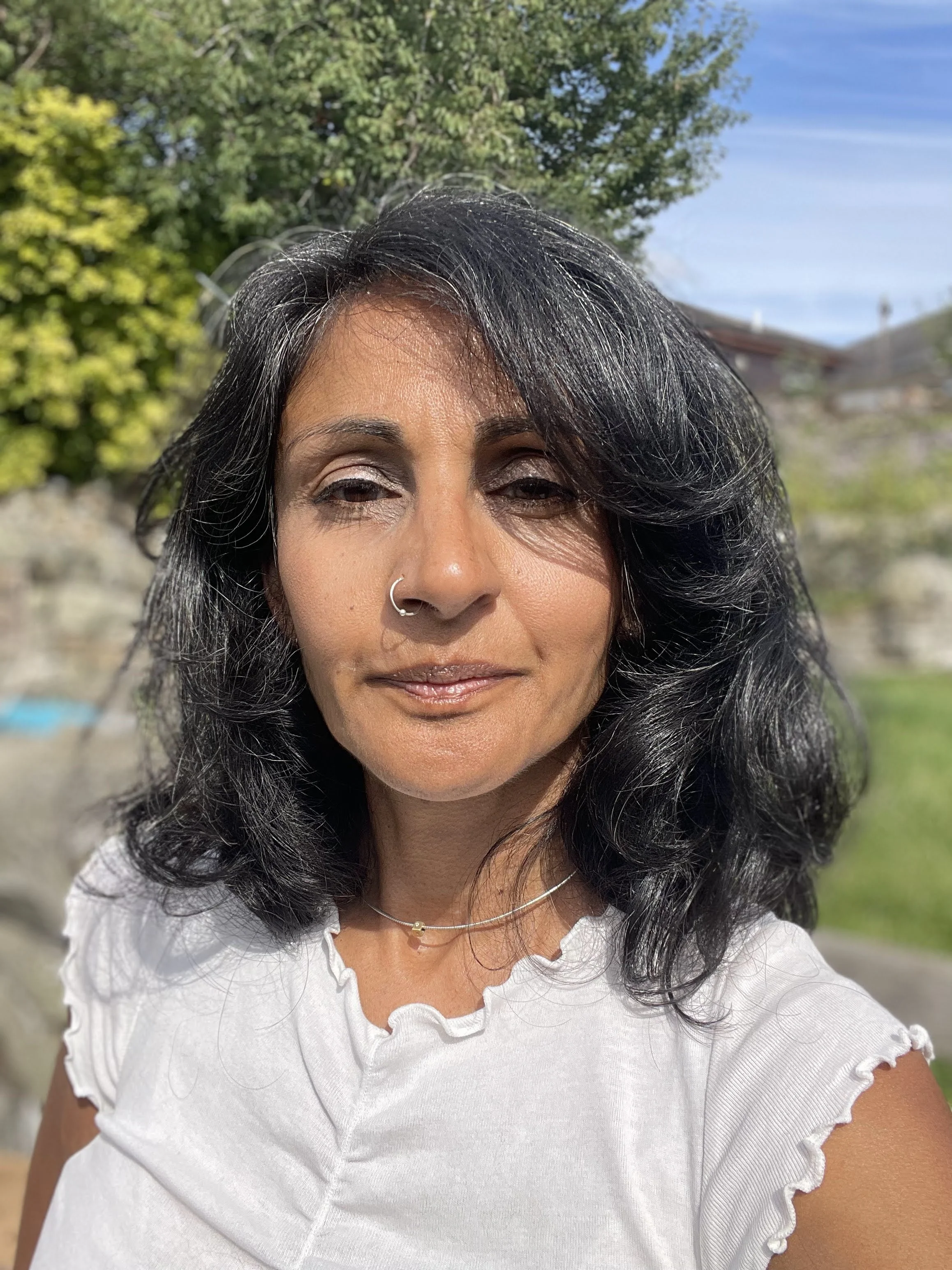 Aneela takes a selfie in the sunshine with grey hairs