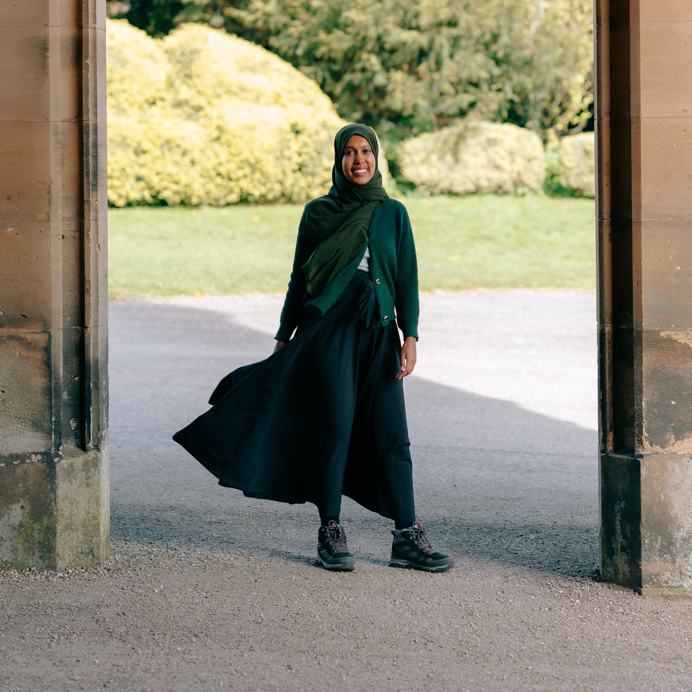Nafisa stood smiling under an archway