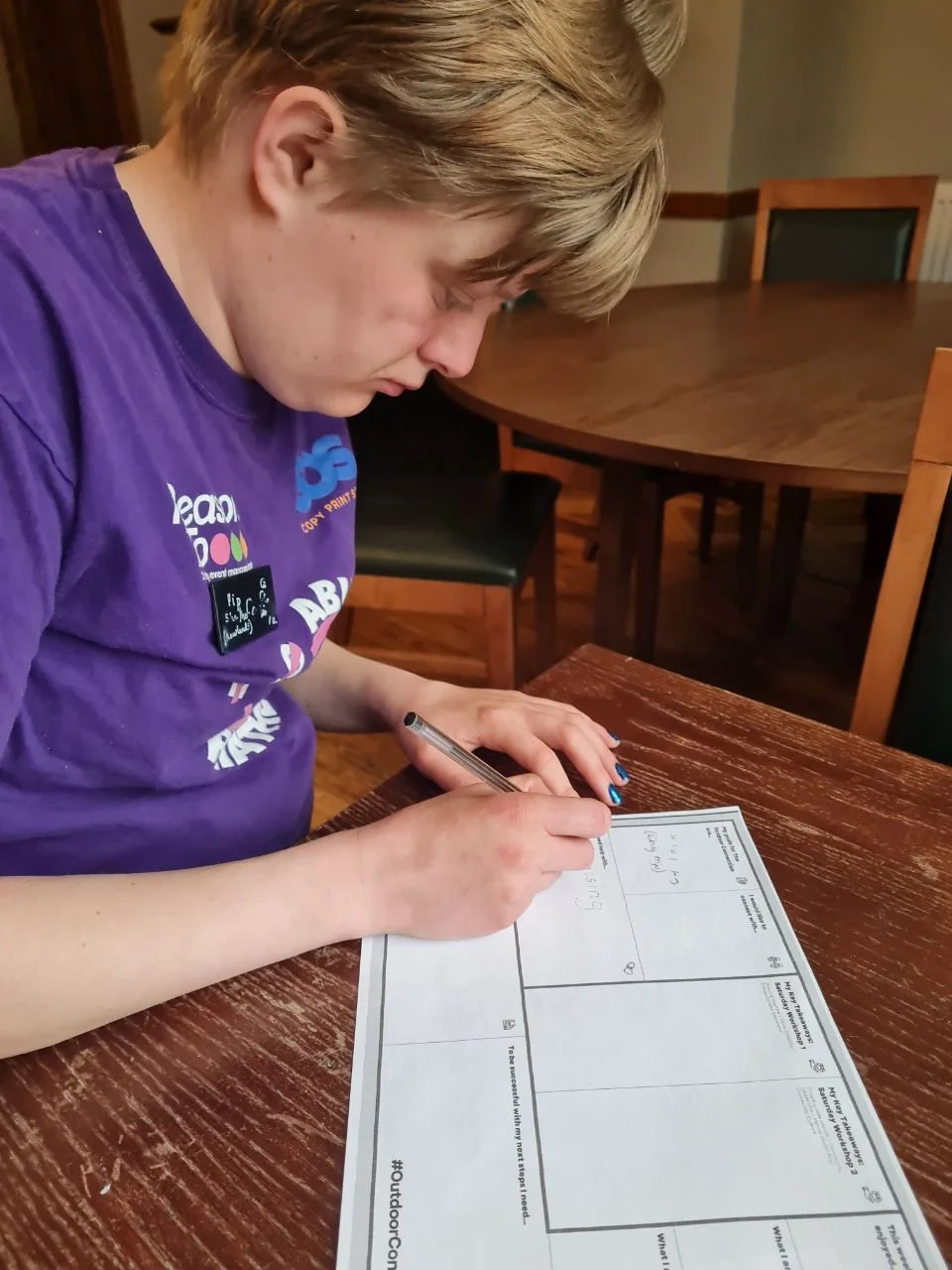 Pip fills out a work sheet from The Outdoor Connection
