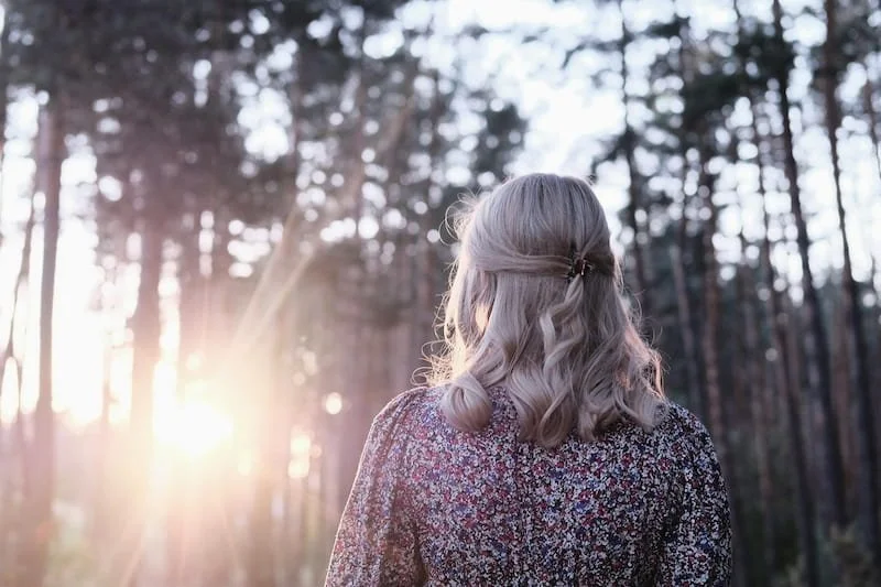A woman walking alone in the woods