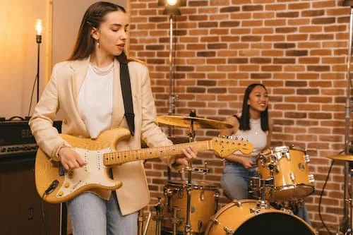 2 women playing in a band looking happy and in the groove