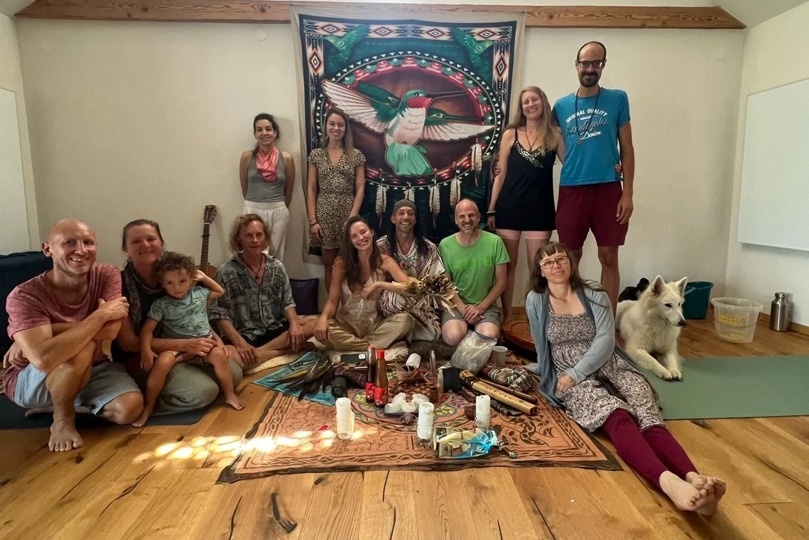 joyful people gathered for a traditional toltec cacao ceremony and an altar with flowers, candles, and musical instruments connected with mexican and toltec culture.