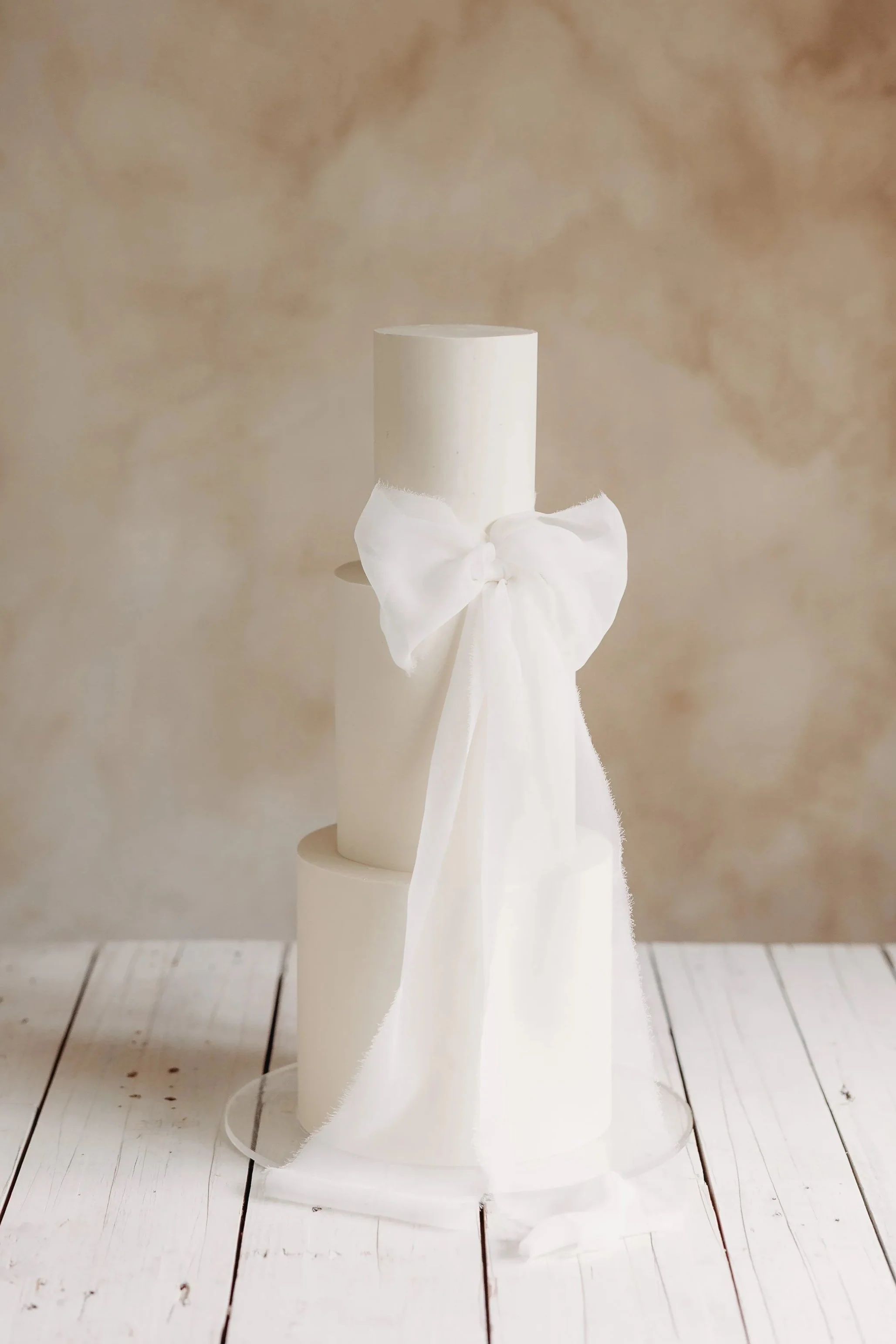 White Cambridge Wedding Cake with silk bow