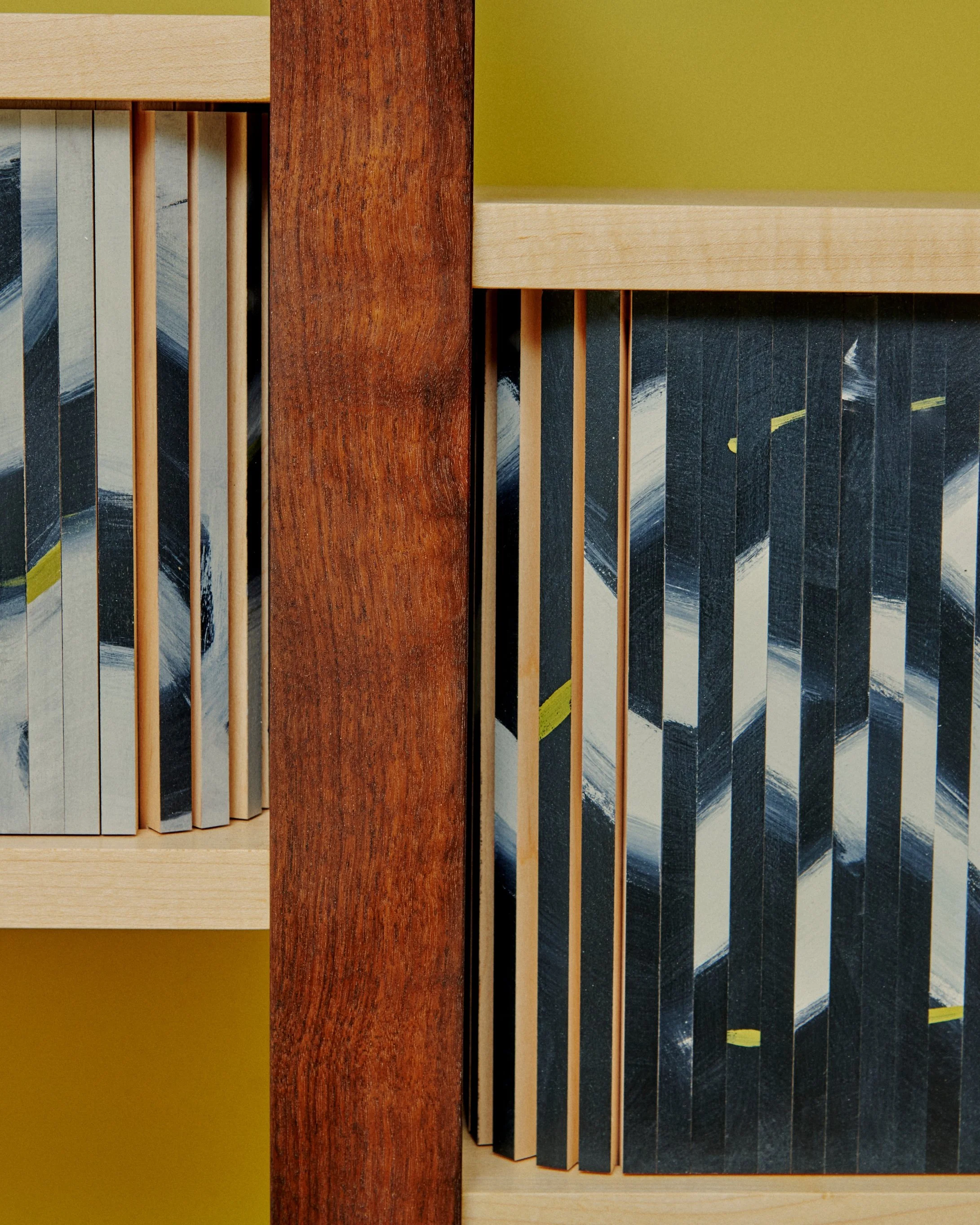 Close-up of wooden panels in various colors and textures, arranged in an abstract pattern. Wendy Maruyama.