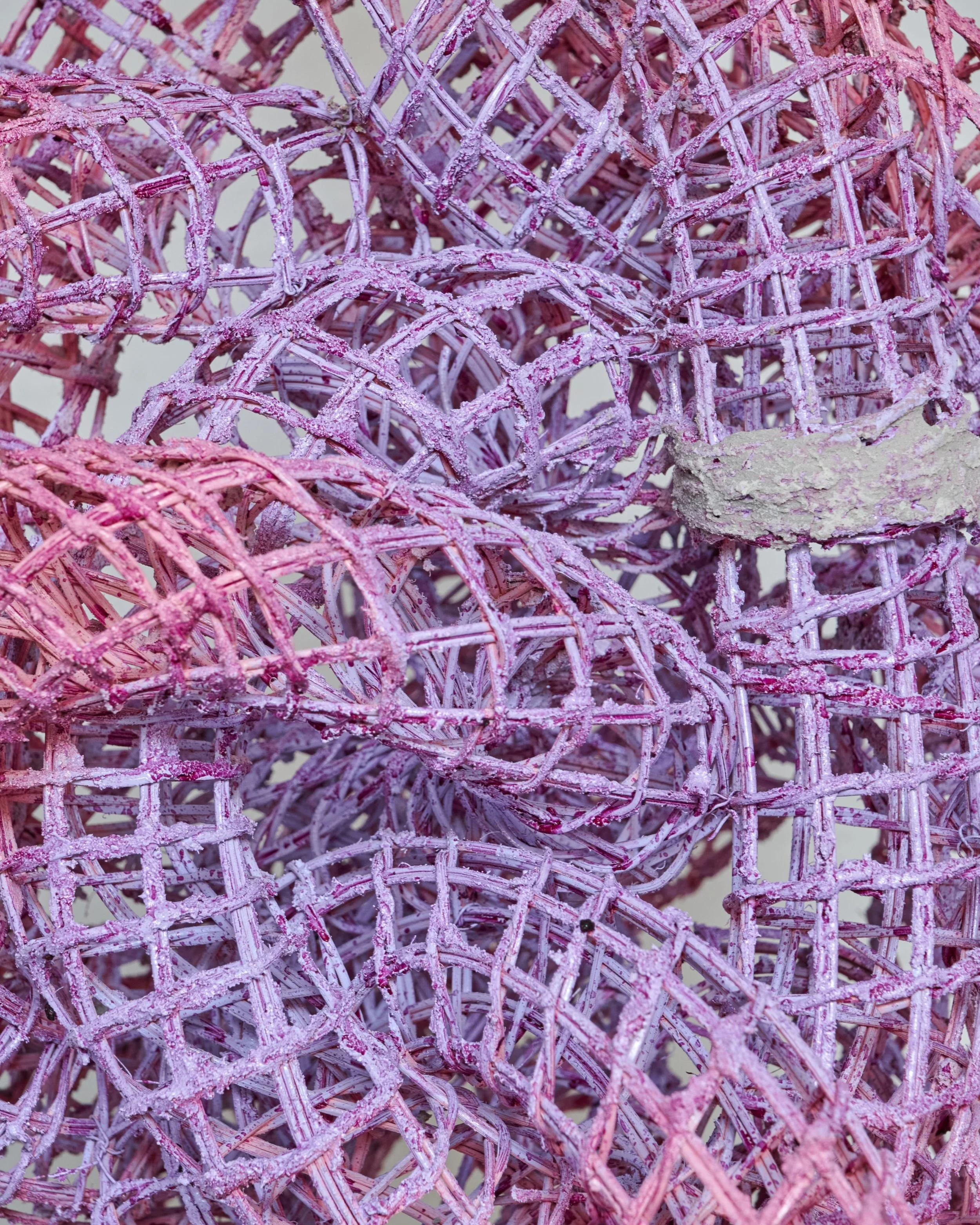 Close-up of pink and purple woven wire baskets.