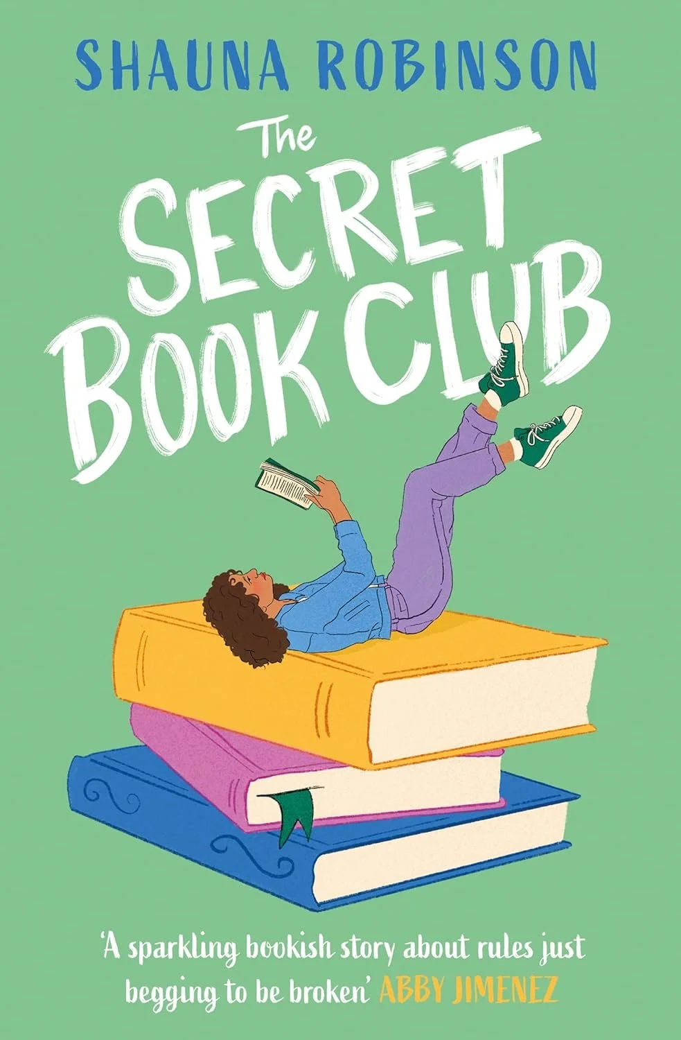 Illustrated green cover showing a Black woman lounging on a pile of oversized books, reading a book